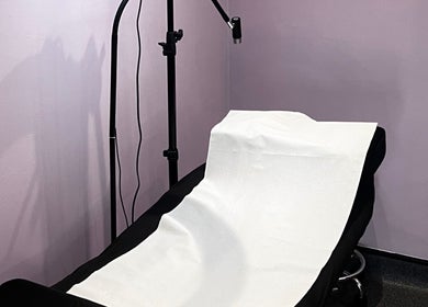Treatment bed in Pro Studio Bournemouth with soft lighting, located in Bournemouth, England, GB.