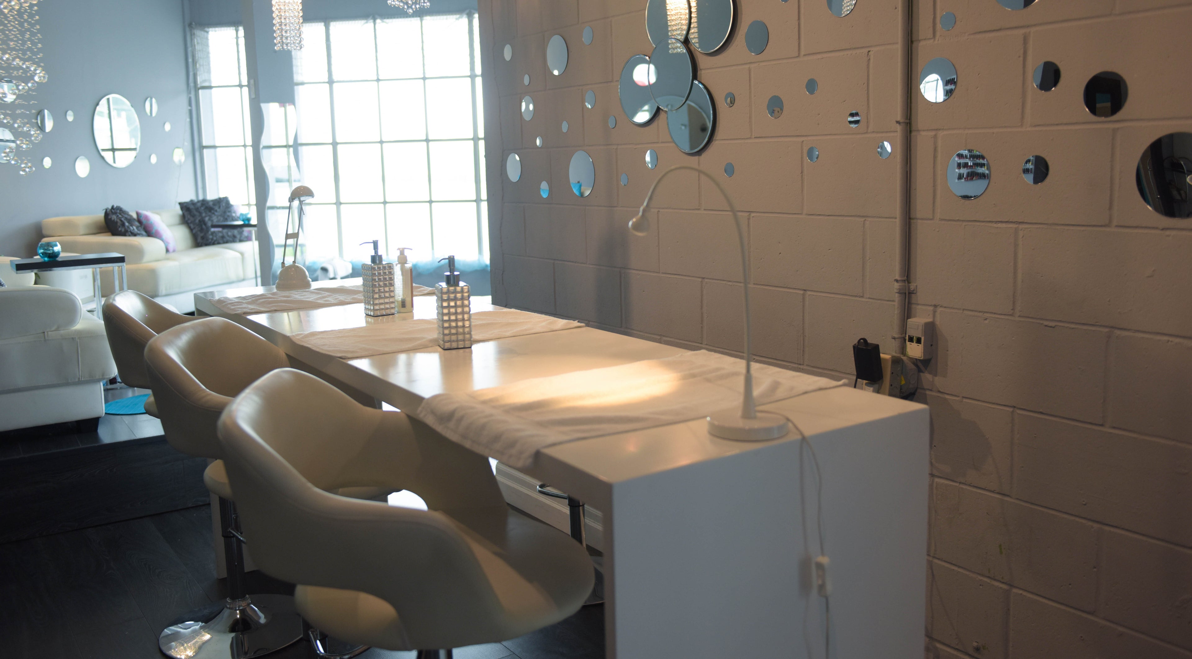 Modern manicure station at Blu Harbour Beauty Bar, Port Stanley, Ontario, CA, with elegant decor and cozy seating.