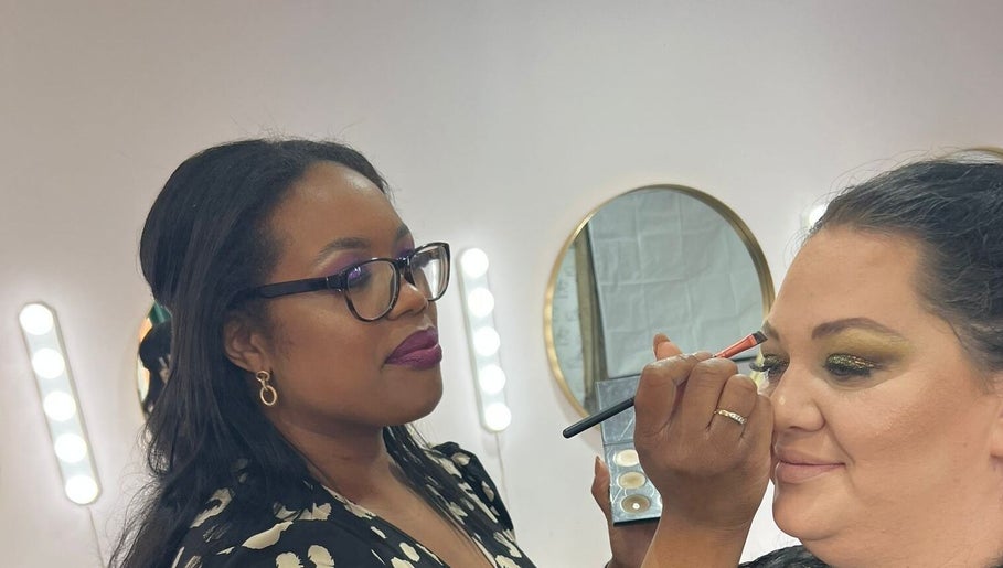 Makeup artist at Glam by Joanna B, Tewkesbury, applies eyeshadow with precision.