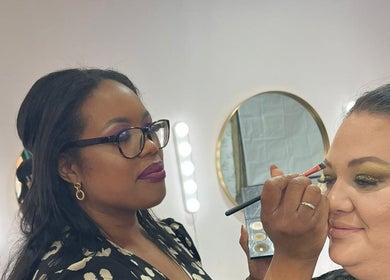 Makeup artist at Glam by Joanna B, Tewkesbury, applies eyeshadow with precision.