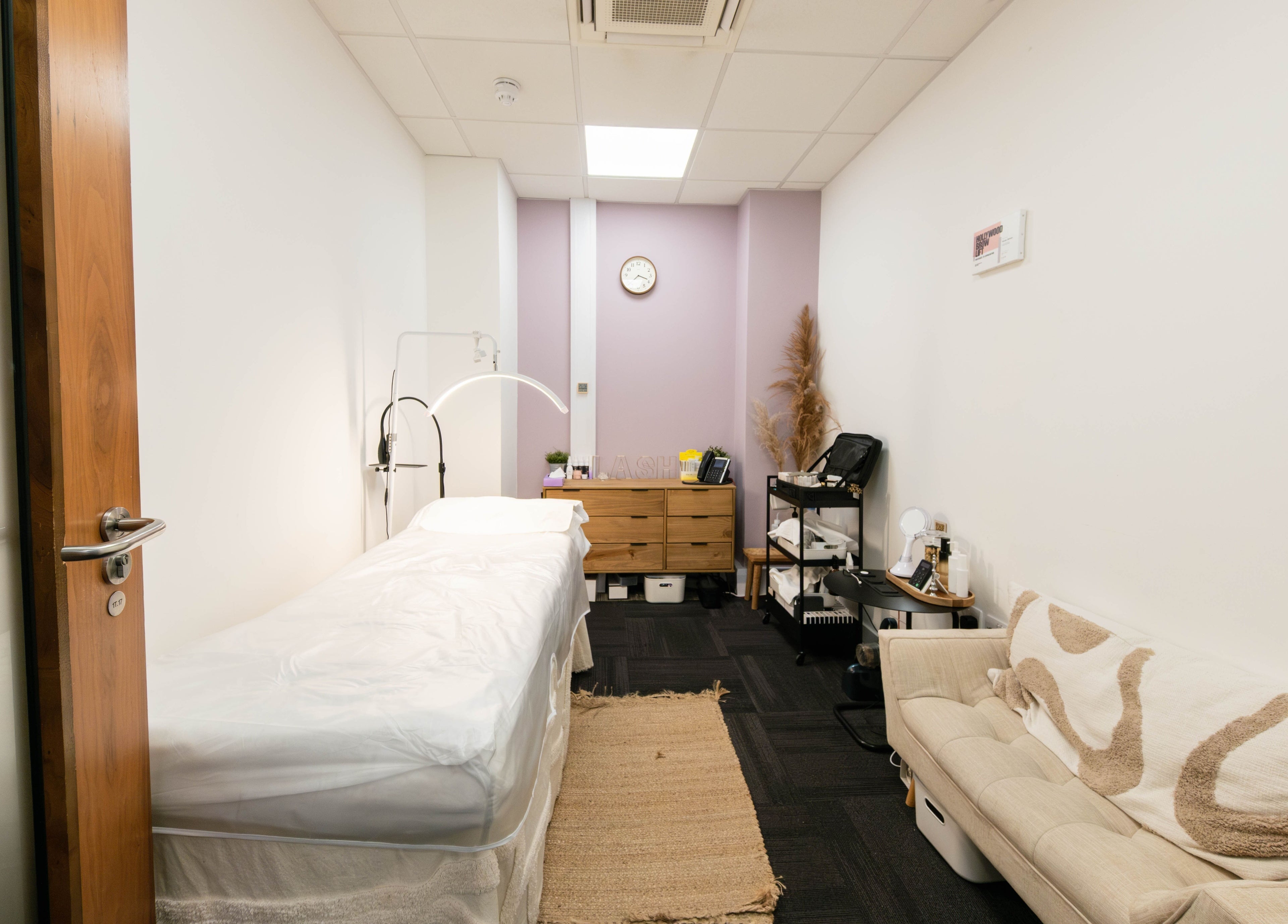 Relaxing treatment room at BIYU Lash Hanover Sq., London, England, GB. Cozy couch and treatment bed.