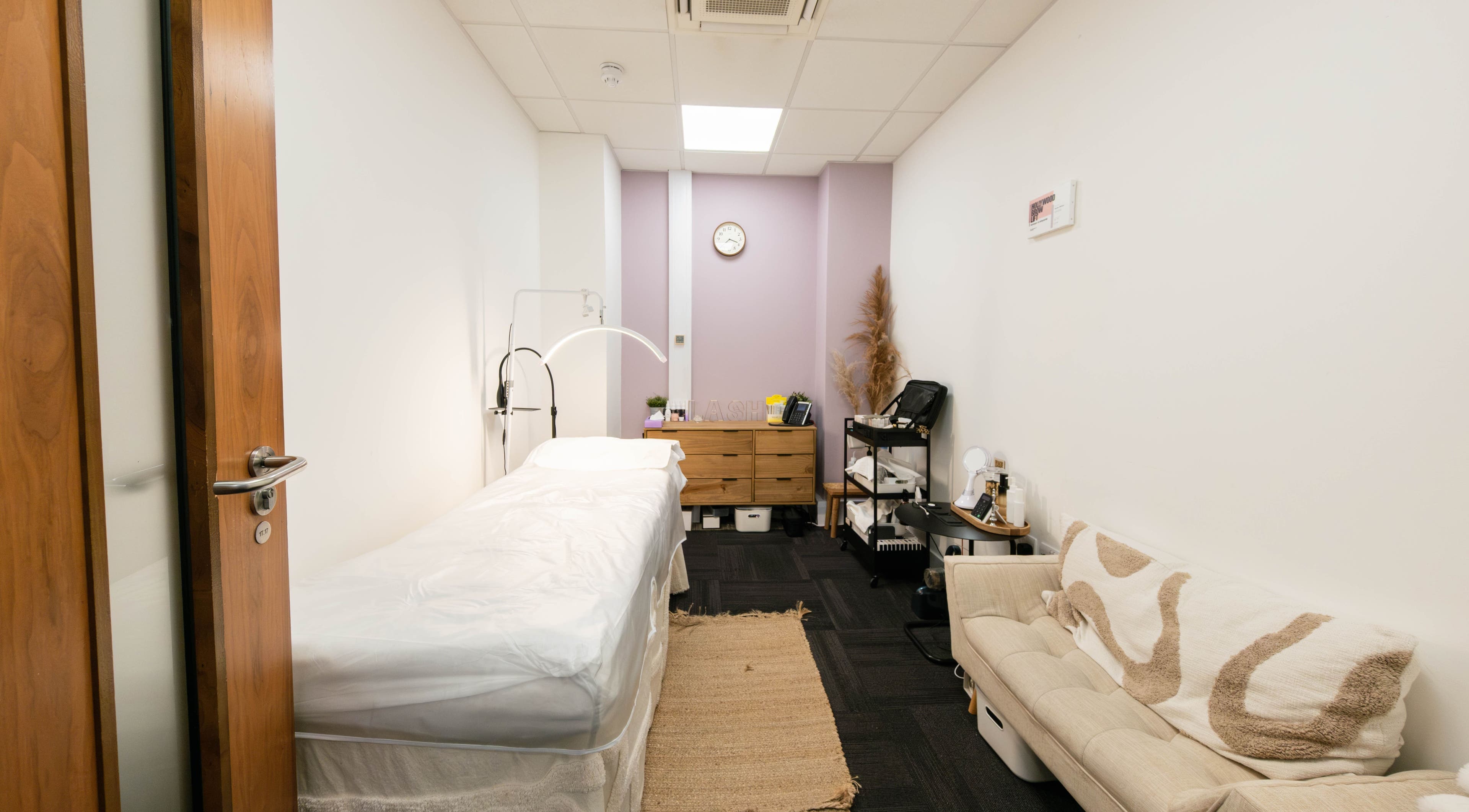 Relaxing treatment room at BIYU Lash Hanover Sq., London, England, GB. Cozy couch and treatment bed.