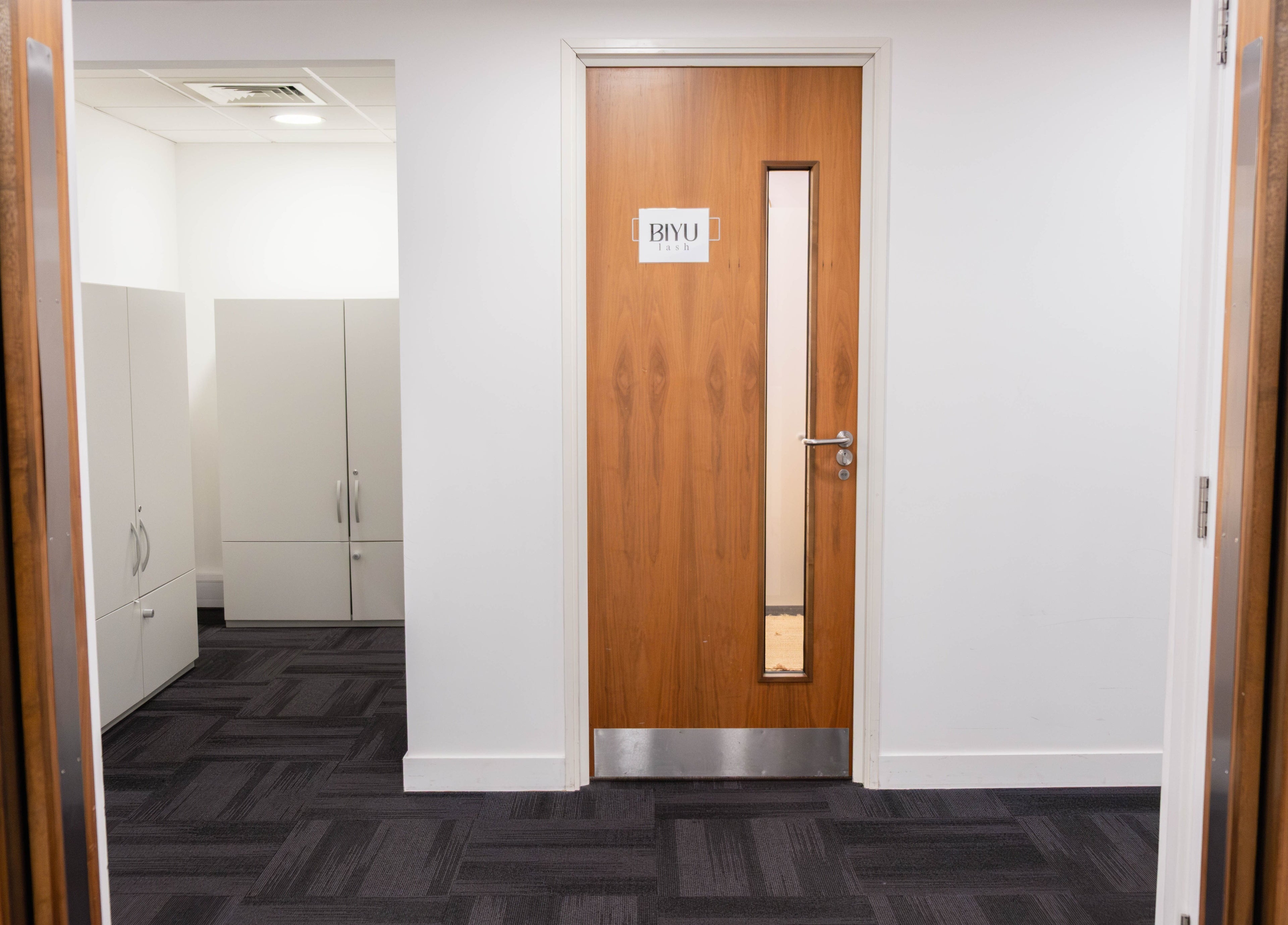 Entrance to BIYU Lash Hanover Sq. with a wooden door and modern interior in London, England, GB.