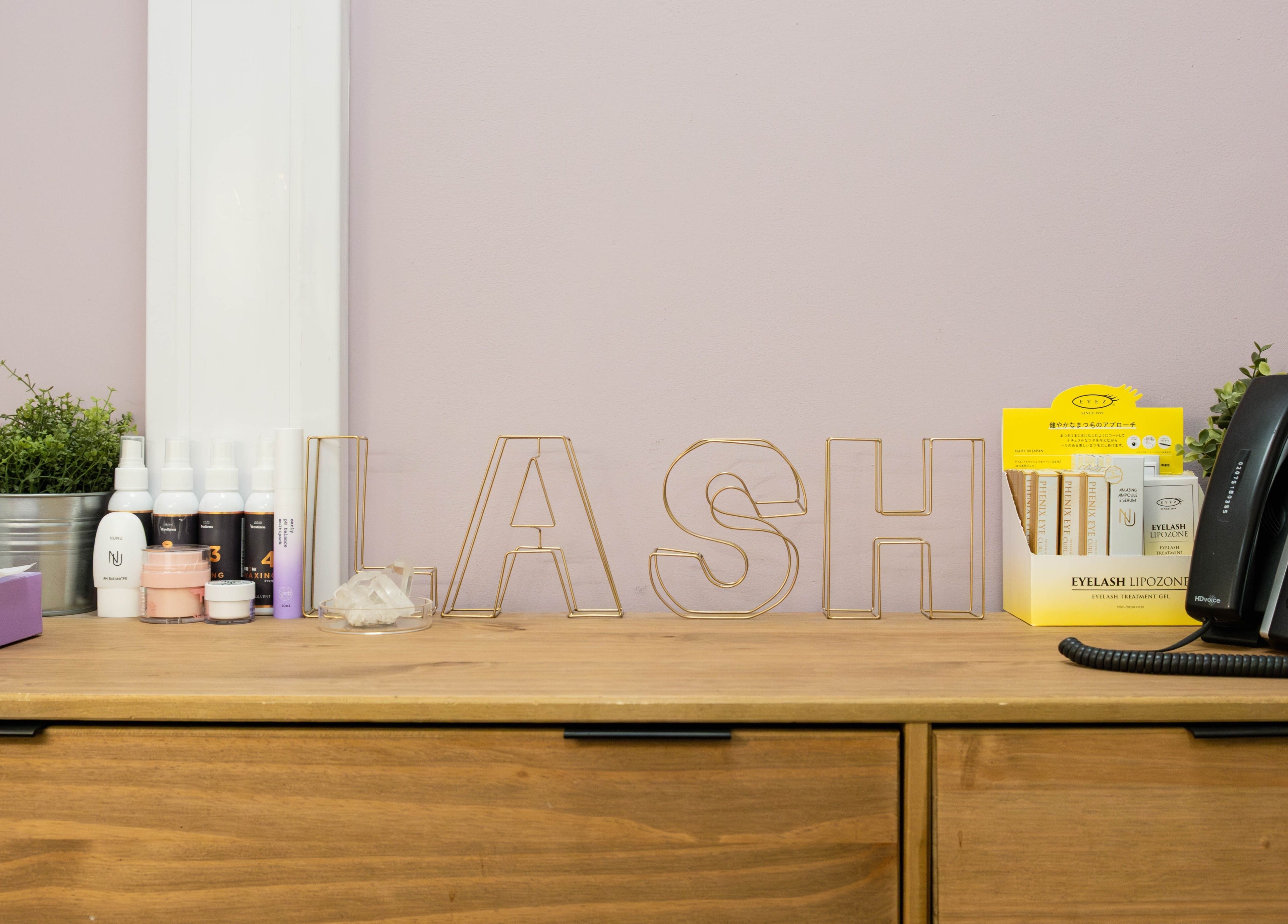 Reception desk at BIYU Lash Hanover Sq., London, England, GB with beauty products and decor.