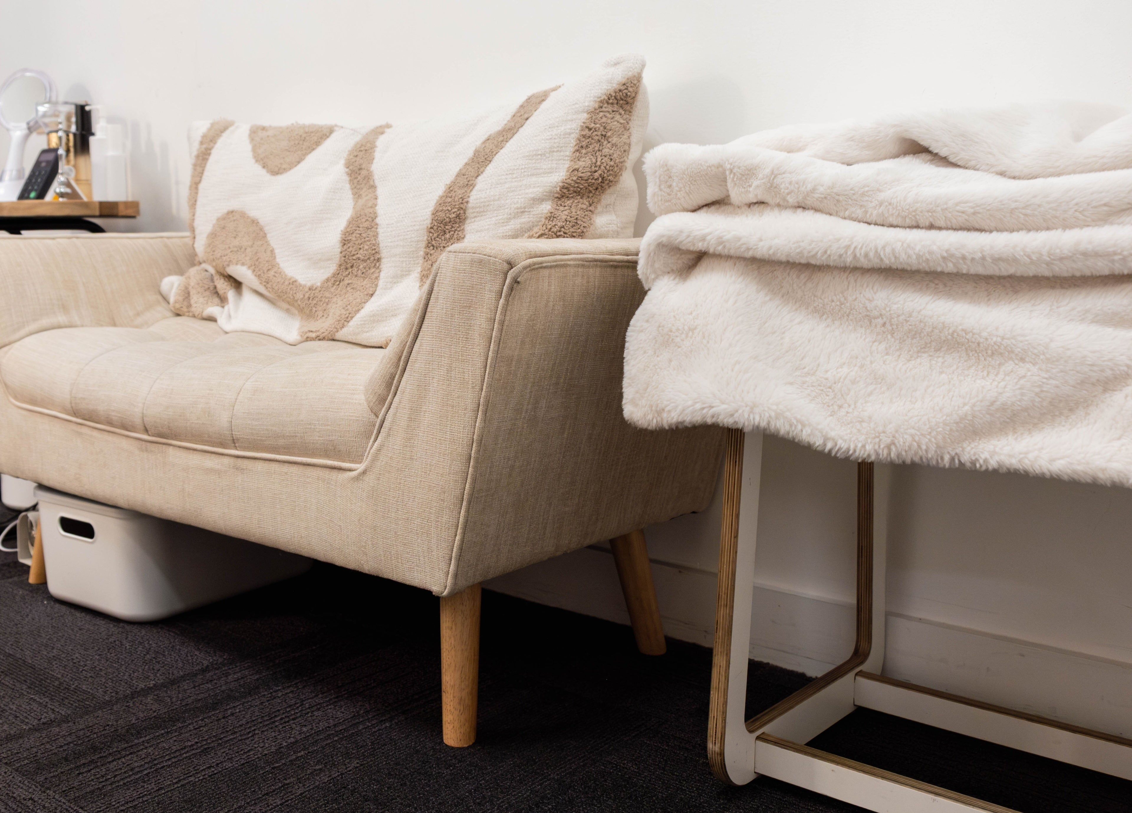 Comfortable seating area at BIYU Lash Hanover Sq., London, England, GB, featuring plush cushions and soft blanket.