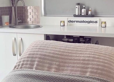Luxurious treatment room at Glow House Beauty, Fareham, England, GB with calming pink tones and Dermalogica products.