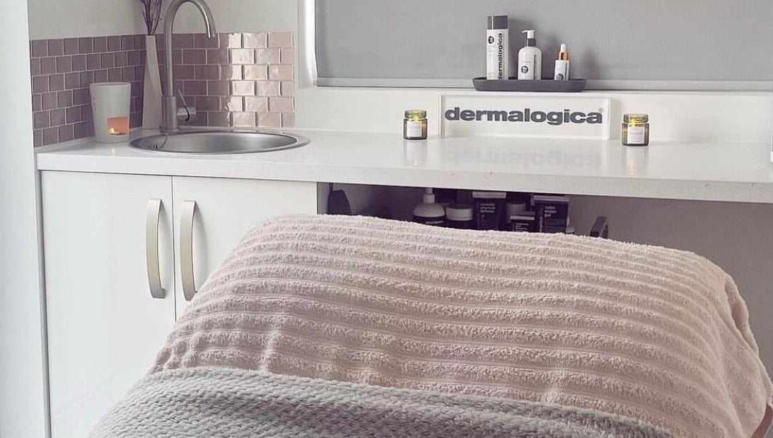 Relaxing treatment room at Glow House Beauty, Fareham, England, GB, featuring Dermalogica products and soothing decor.