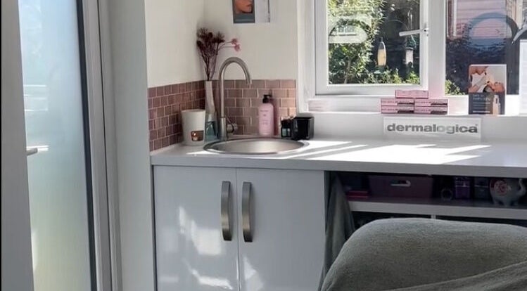 Modern sink area at Glow House Beauty, Fareham, England, GB, featuring Dermalogica products and ambient decor.