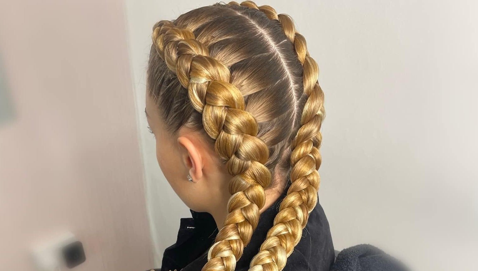 Detailed view of intricate golden braids at CoCo Braids and Brows (Rugby), Rugby, England, GB.