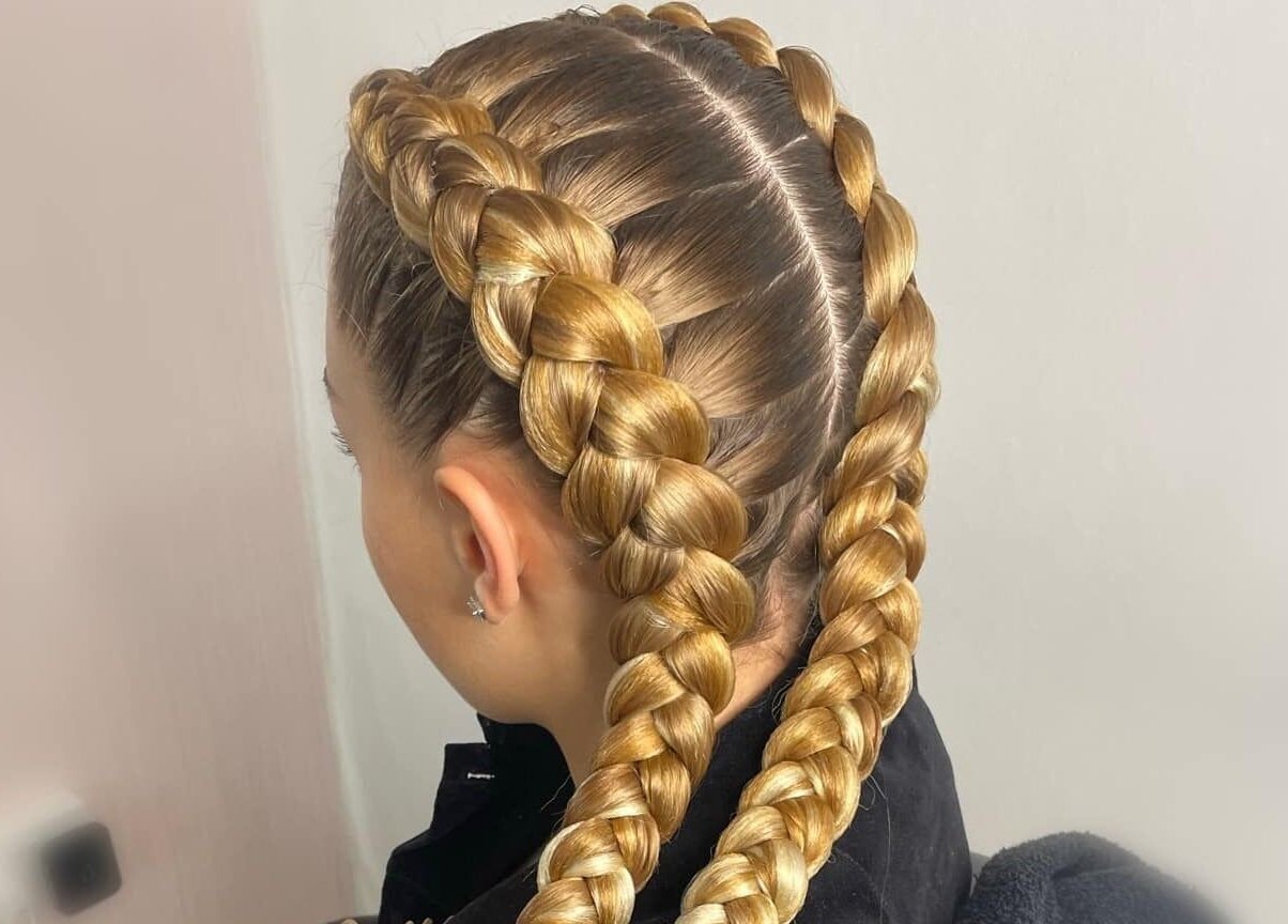 Detailed view of intricate golden braids at CoCo Braids and Brows (Rugby), Rugby, England, GB.