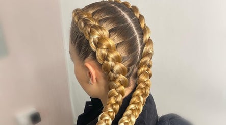 Detailed view of intricate golden braids at CoCo Braids and Brows (Rugby), Rugby, England, GB.