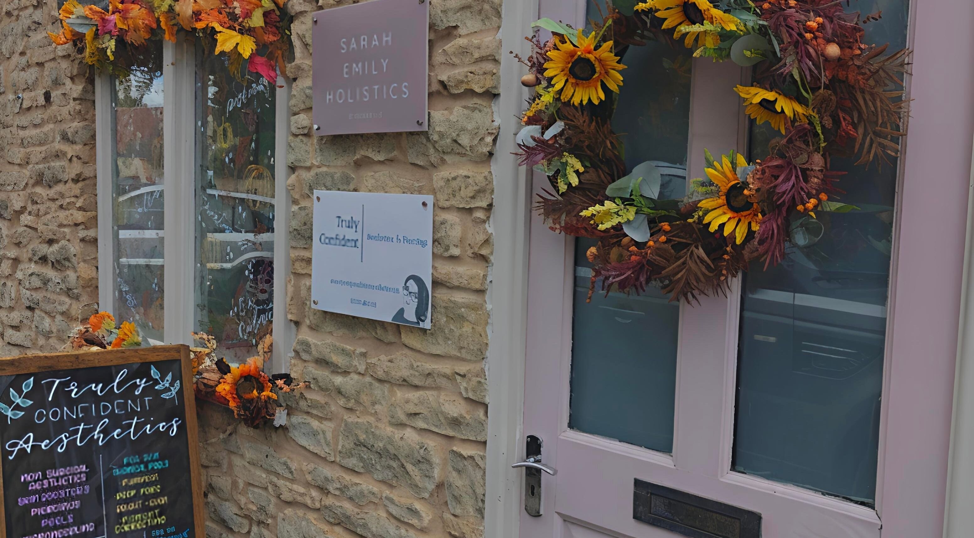 Entrance of Truly Confident Aesthetics in Helpston, England, adorned with vibrant autumn decorations.