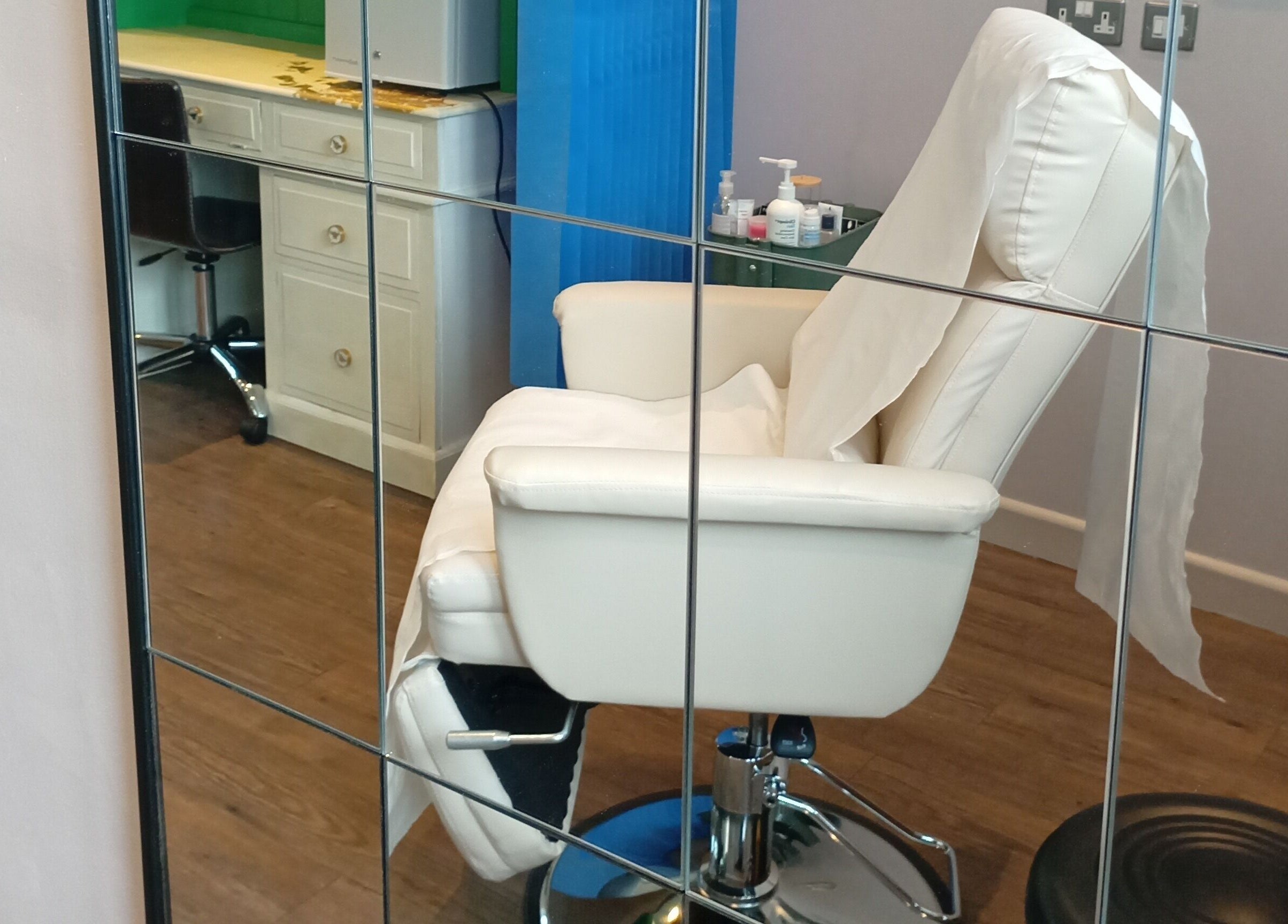 Elegant treatment chair in mirrored room at Truly Confident Aesthetics, Helpston, England, GB.