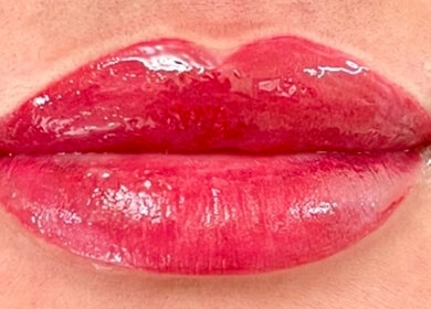 Shiny, vibrant red lips showcased in Matthews, North Carolina, US, highlighting expert beauty care.
