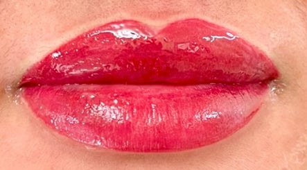Shiny, vibrant red lips showcased in Matthews, North Carolina, US, highlighting expert beauty care.