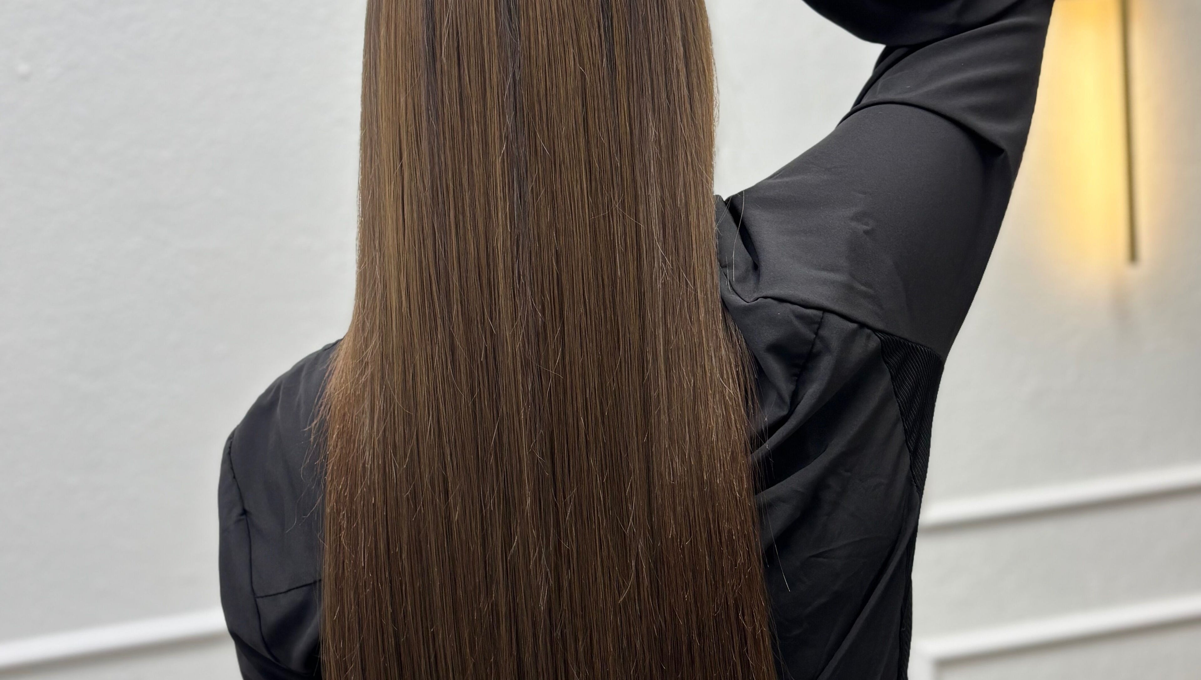 Sleek, long brown hair at Erika Lara salon, El Paso, Texas, US. Shiny and smooth style.
