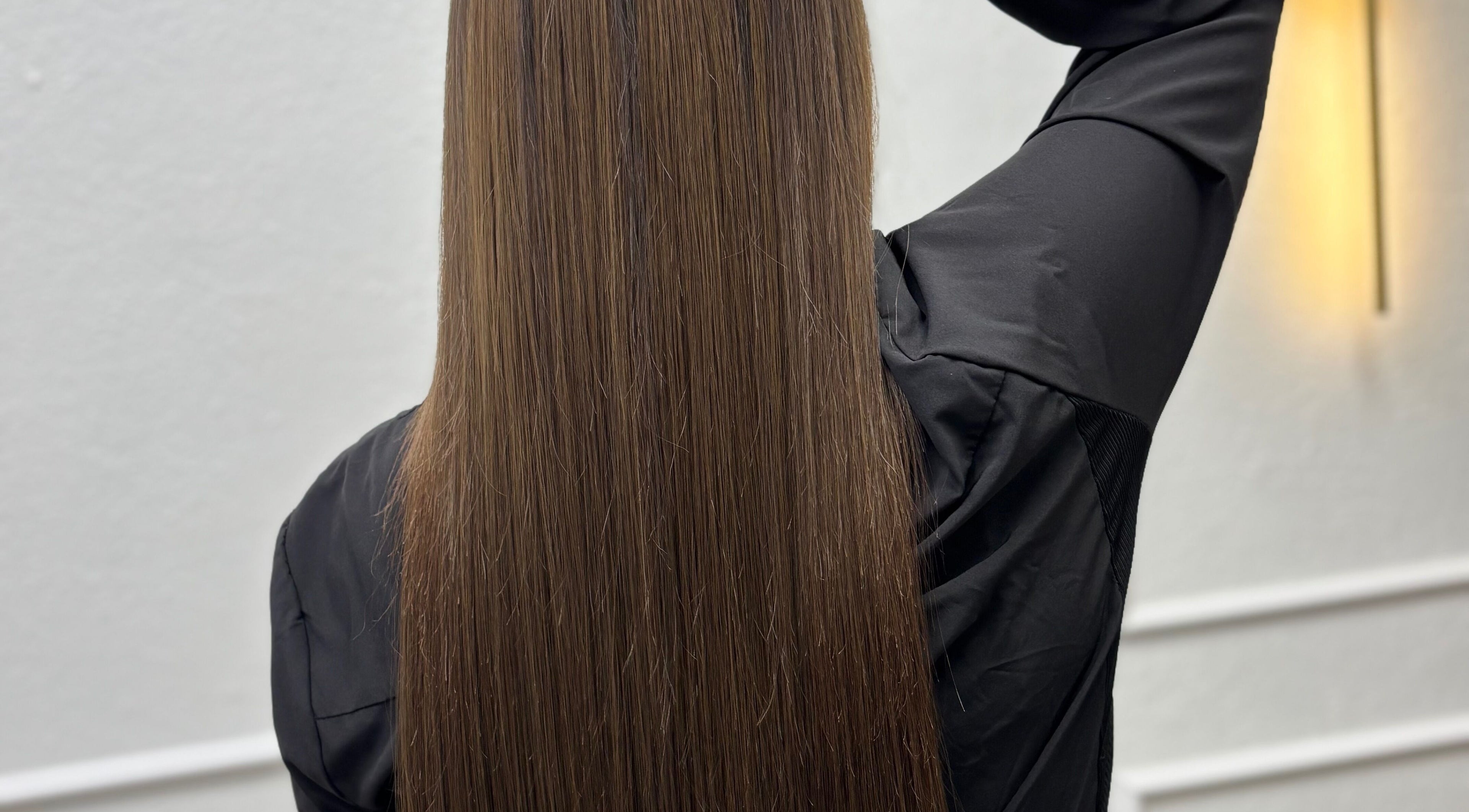Sleek, long brown hair at Erika Lara salon, El Paso, Texas, US. Shiny and smooth style.