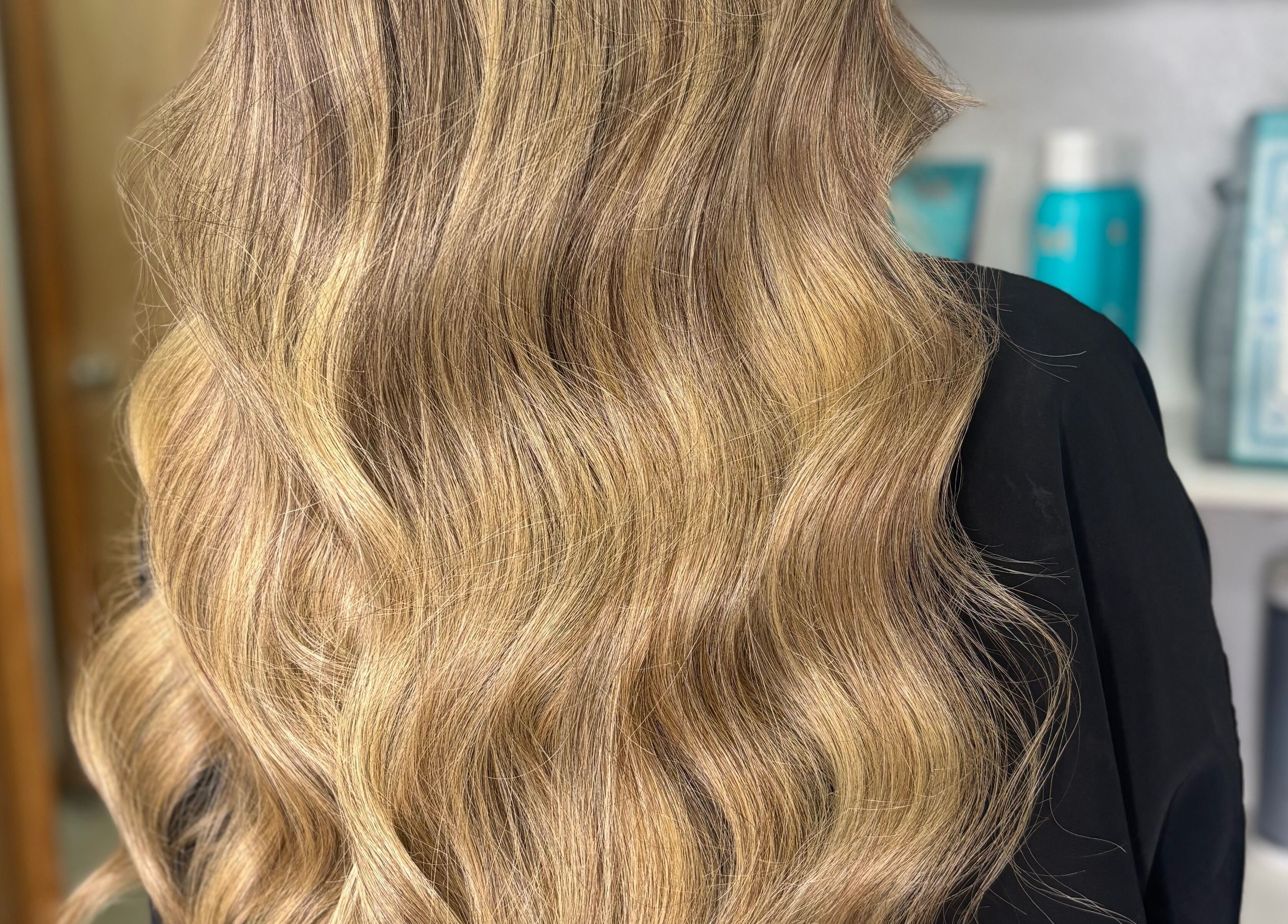 Shiny blonde waves styled at Erika Lara, El Paso, Texas, US showcasing salon expertise.