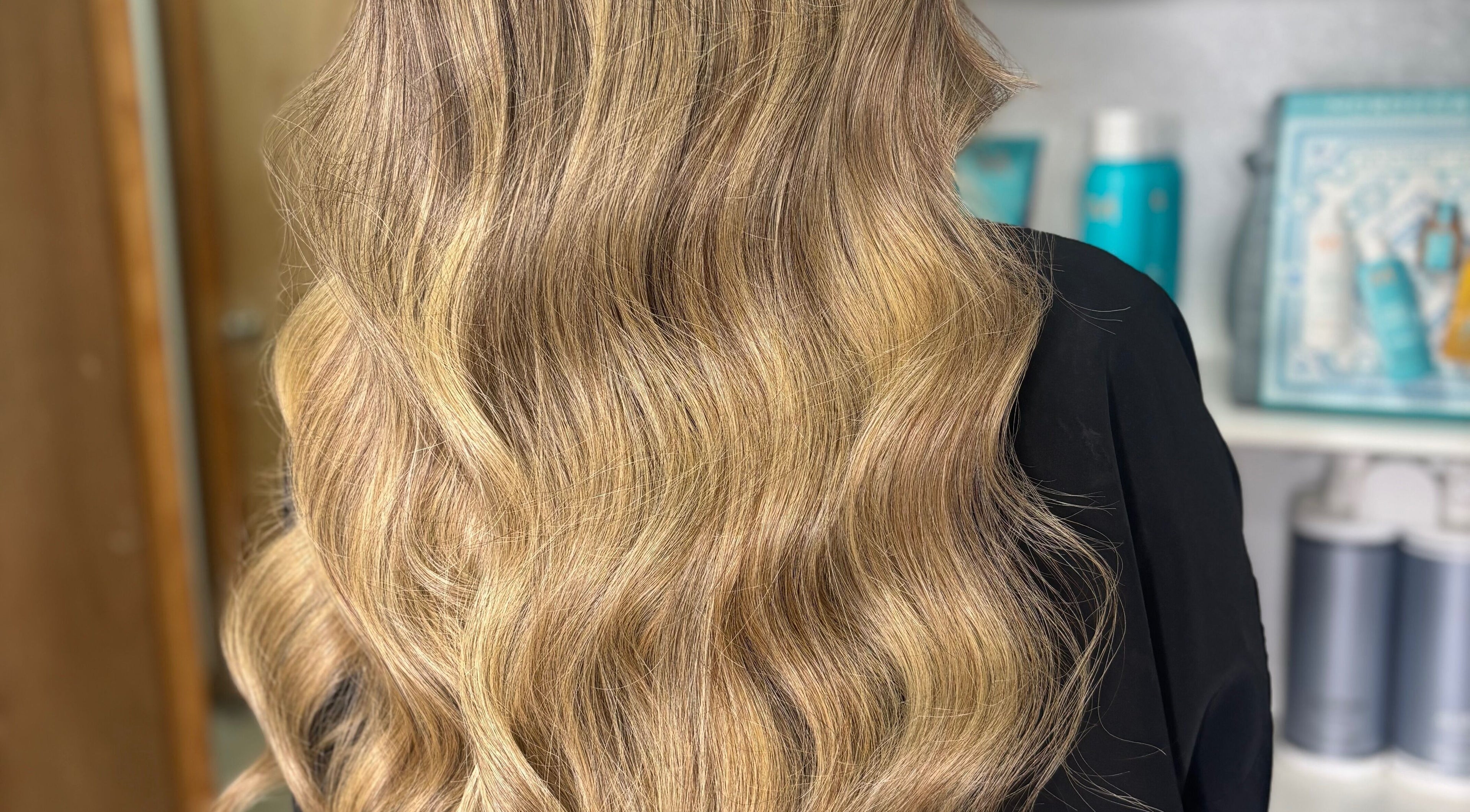 Shiny blonde waves styled at Erika Lara, El Paso, Texas, US showcasing salon expertise.