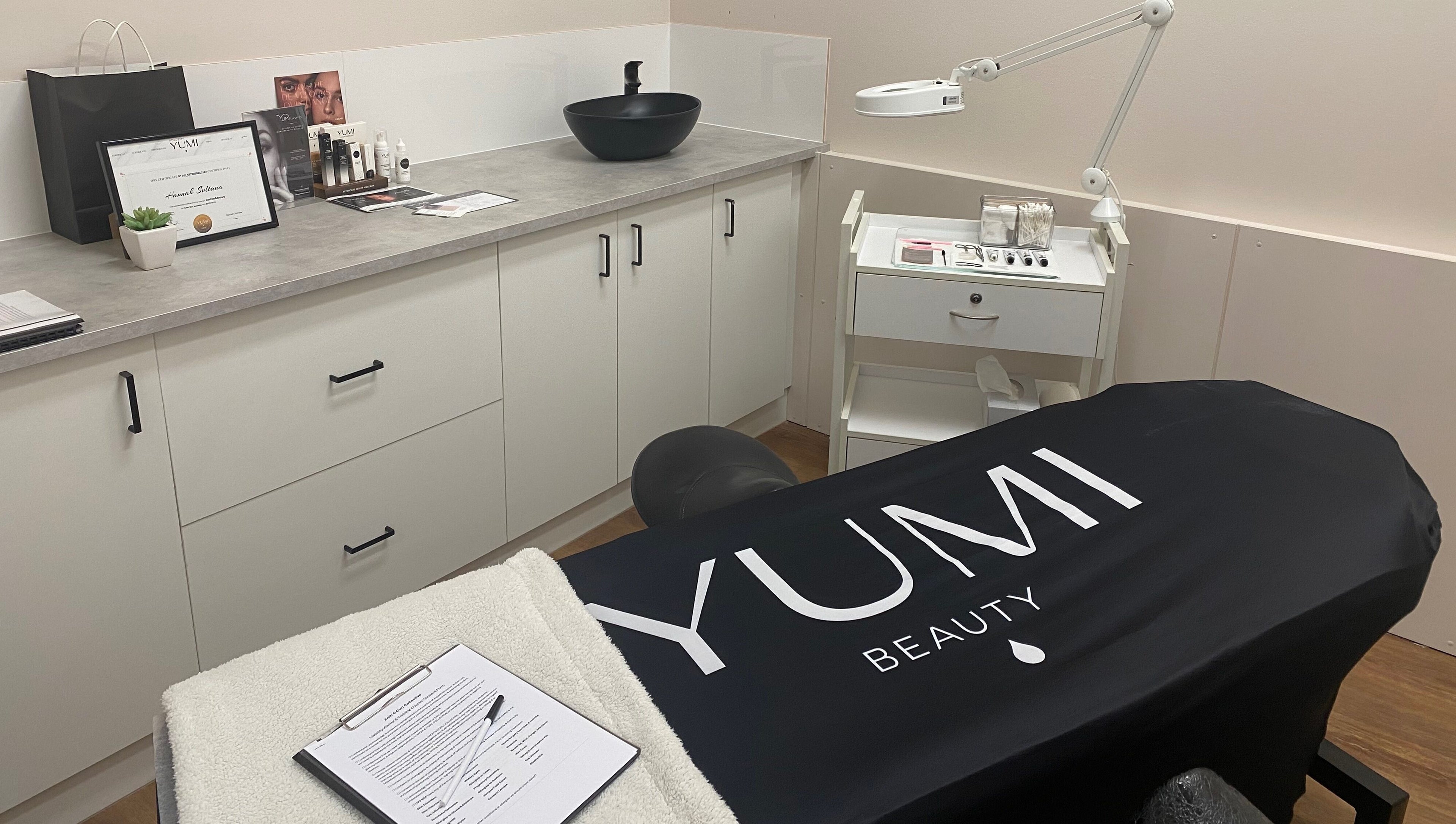 A treatment room at Arch & Curl Collective, Joondalup, Western Australia, AU, featuring cozy decor.