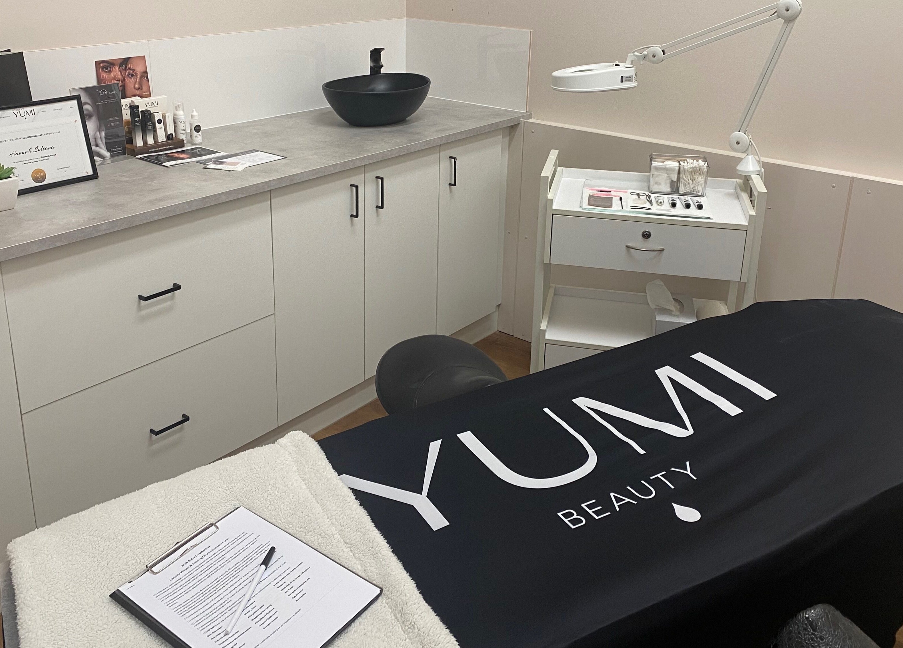 A treatment room at Arch & Curl Collective, Joondalup, Western Australia, AU, featuring cozy decor.