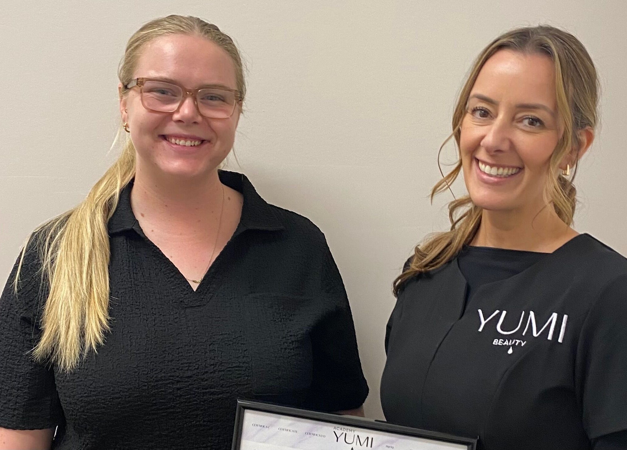 Team at Arch & Curl Collective in Joondalup, WA, AU showcasing a certificate of achievement.