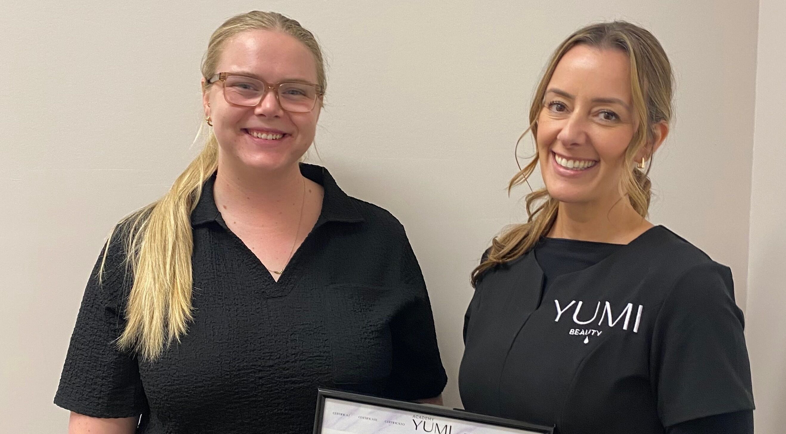 Team at Arch & Curl Collective in Joondalup, WA, AU showcasing a certificate of achievement.