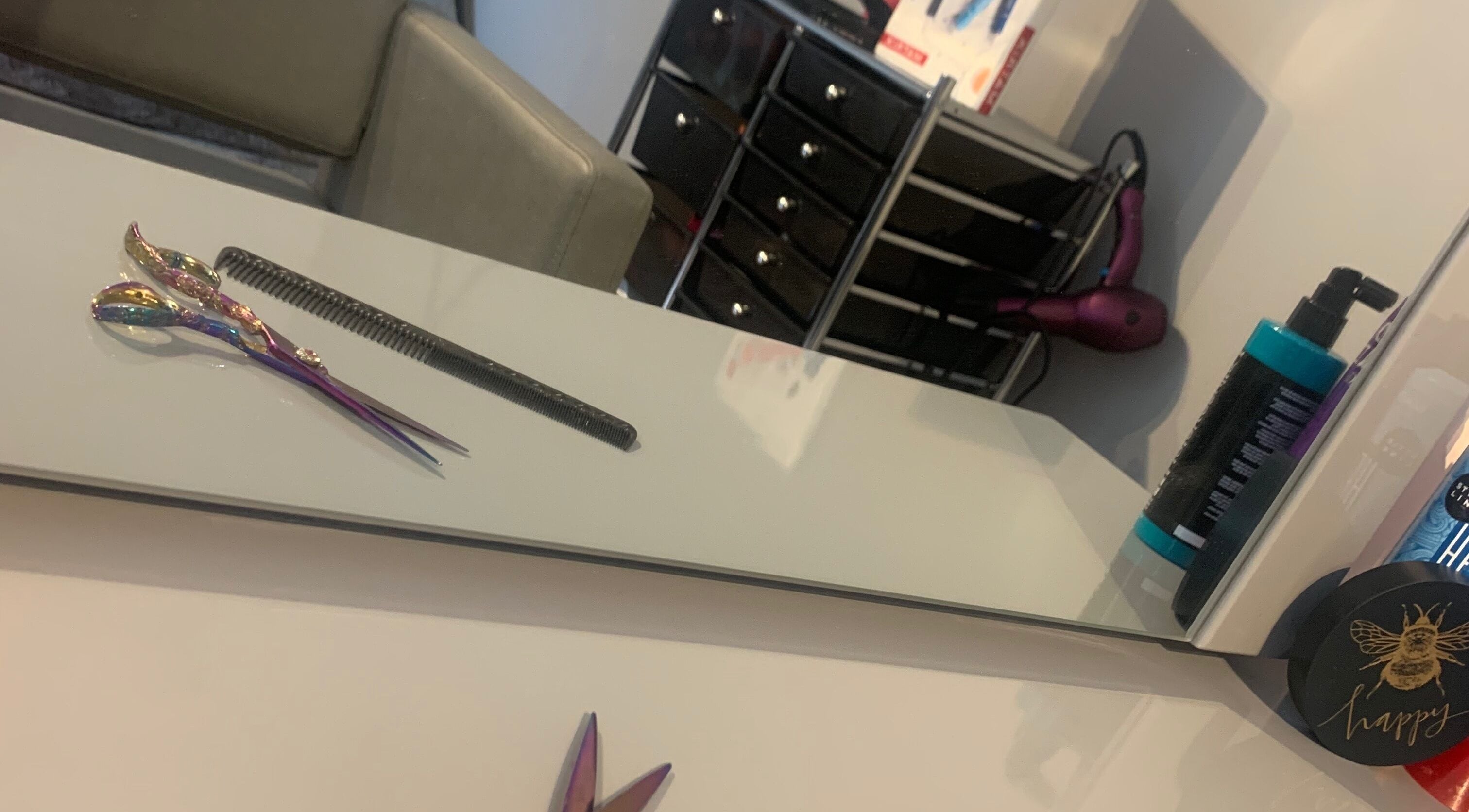 Colorful scissors and hair styling tools at Melamorphosis, Bideford, England, GB salon.