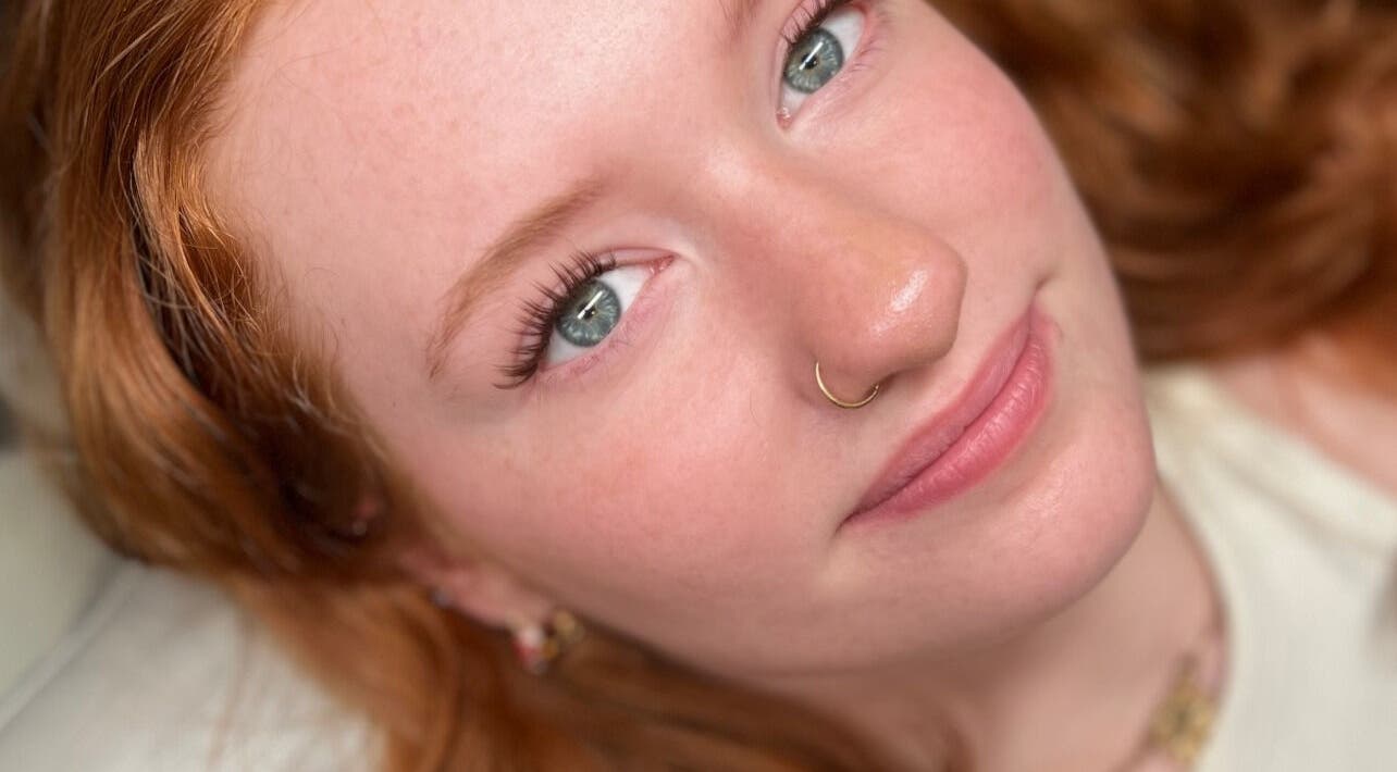 Close-up of a young woman with vibrant red hair at Aesthetics by Ninoska, Bonney Lake, Washington, US.