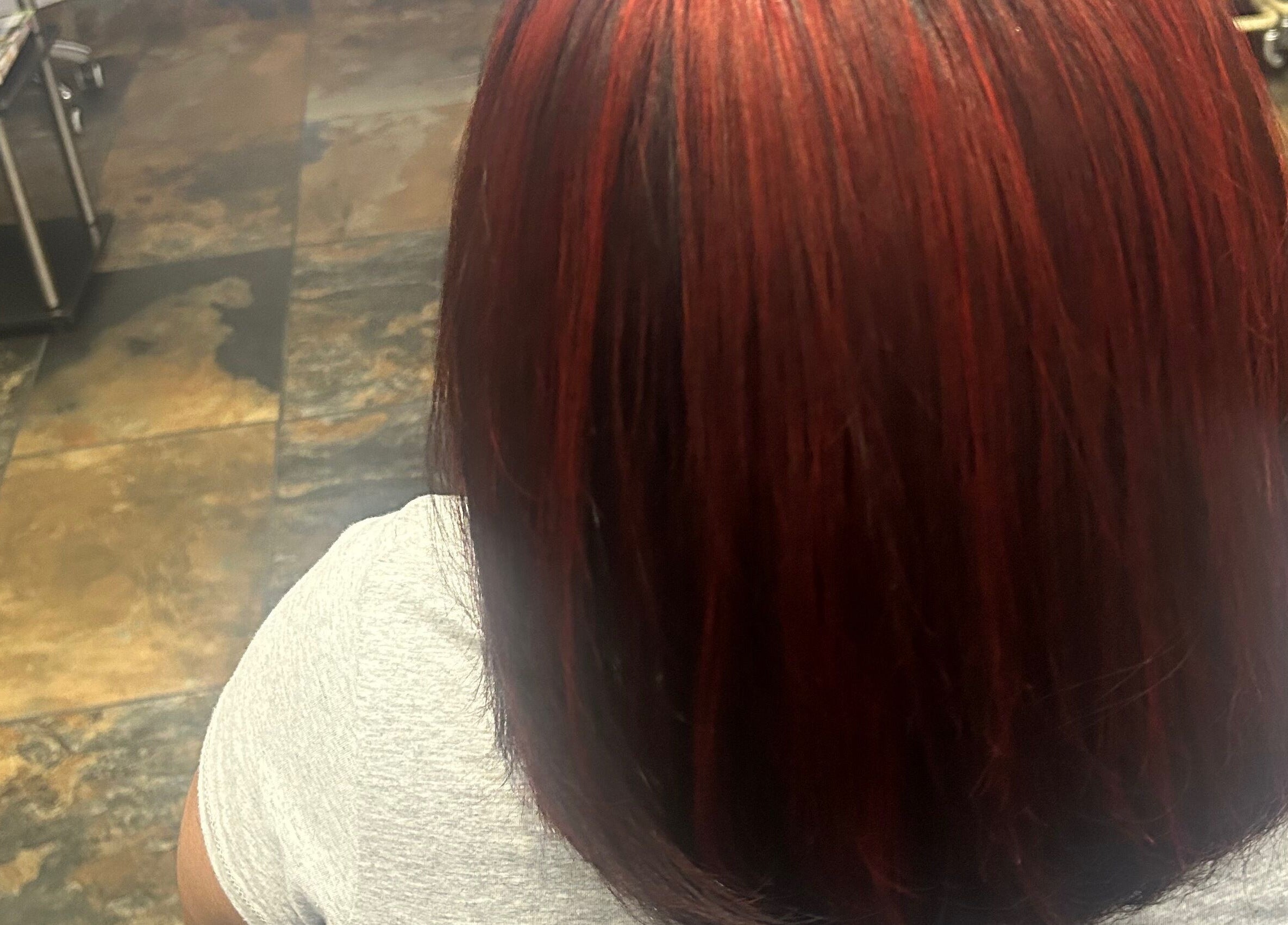 Vibrant red hair treatment at My Butopia Salon in Ajax, Ontario, CA showcasing shiny, sleek results.