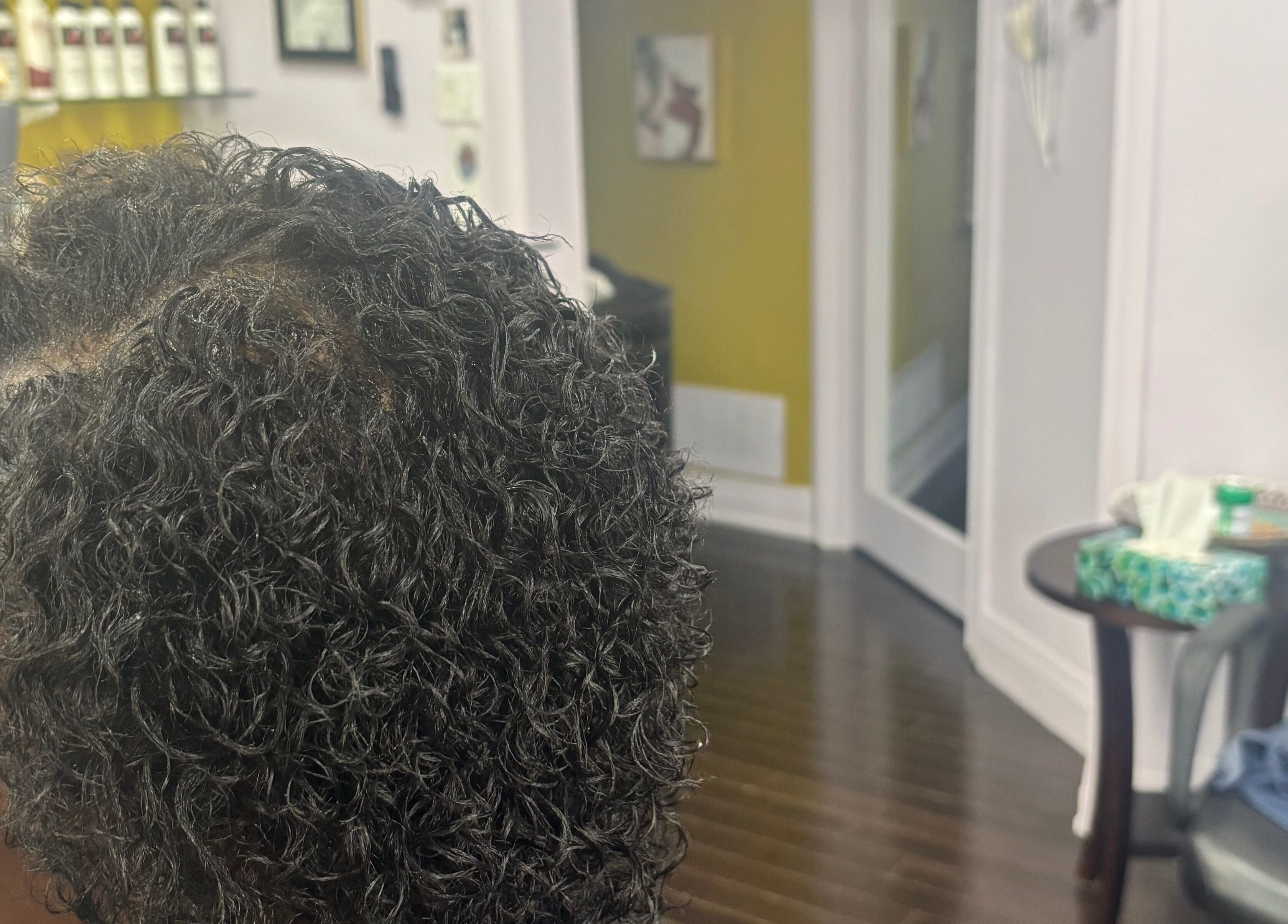 Styled curly hair at My Butopia Salon, Ajax, Ontario, CA, showcasing sleek salon interior.
