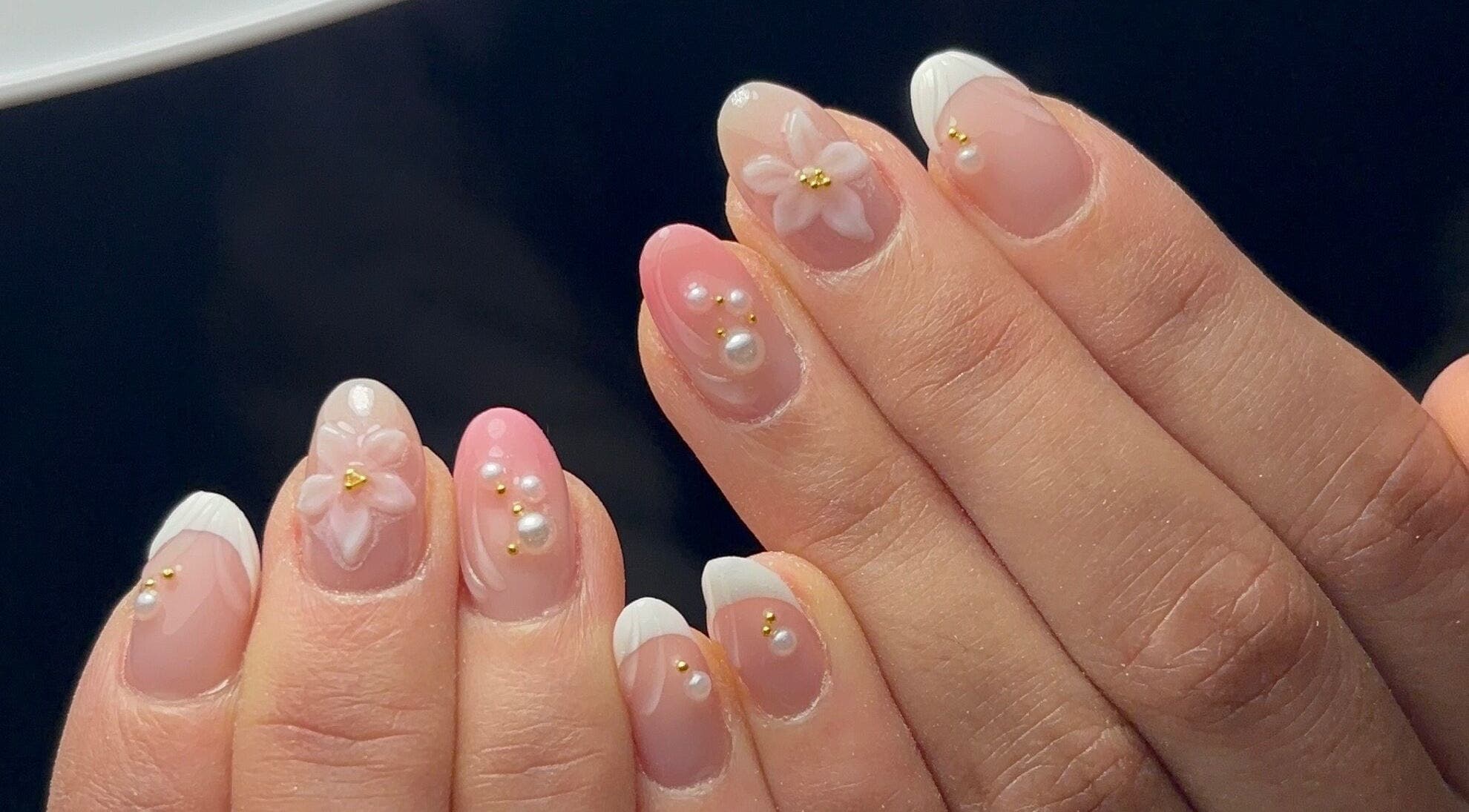 Elegant floral and pearl nail art at Kana's Alter Ego Nail Studio, Ashmore, Queensland, AU.