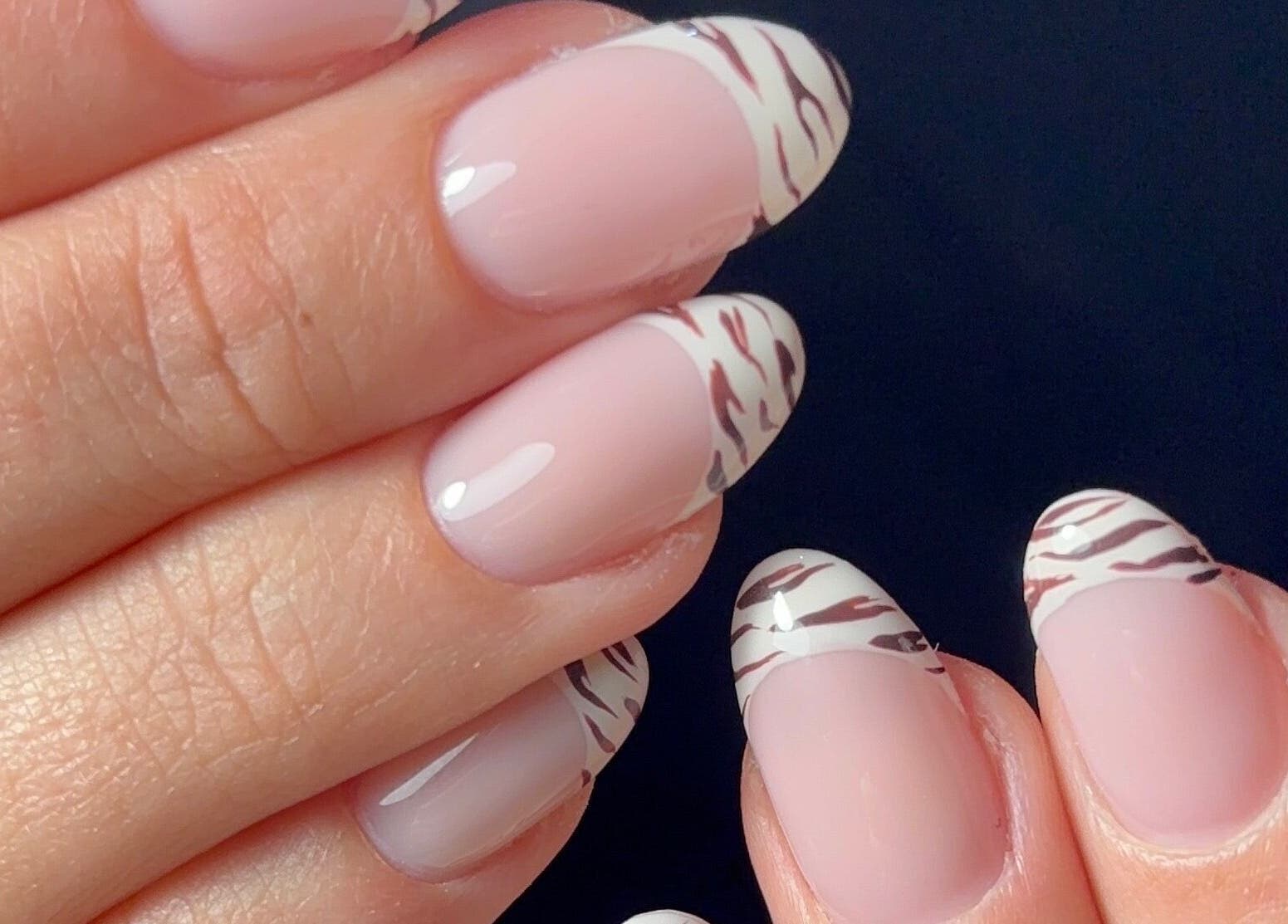 Stylish zebra French nails at Kana's Alter Ego Nail Studio, Ashmore, Queensland, AU.