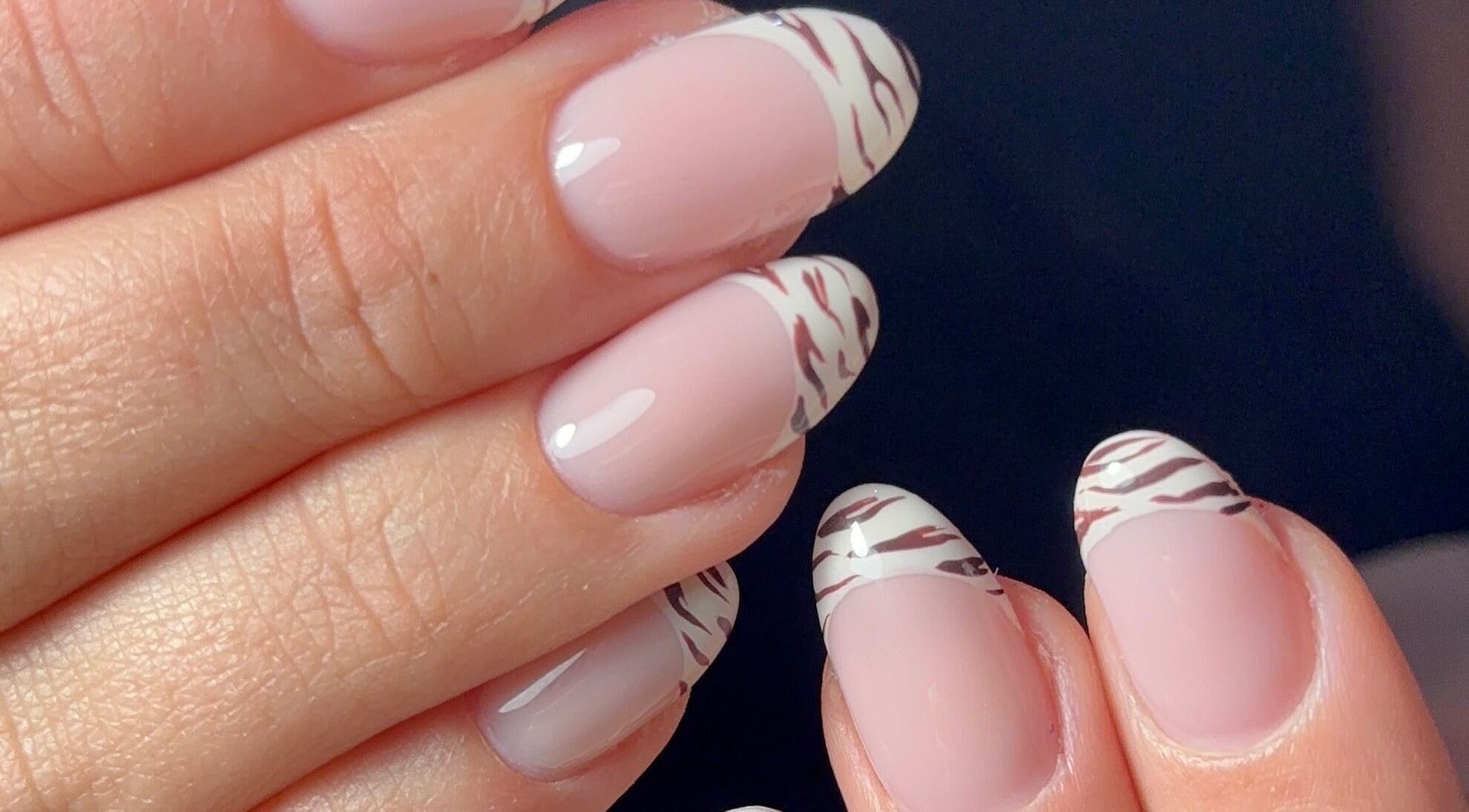 Stylish zebra French nails at Kana's Alter Ego Nail Studio, Ashmore, Queensland, AU.