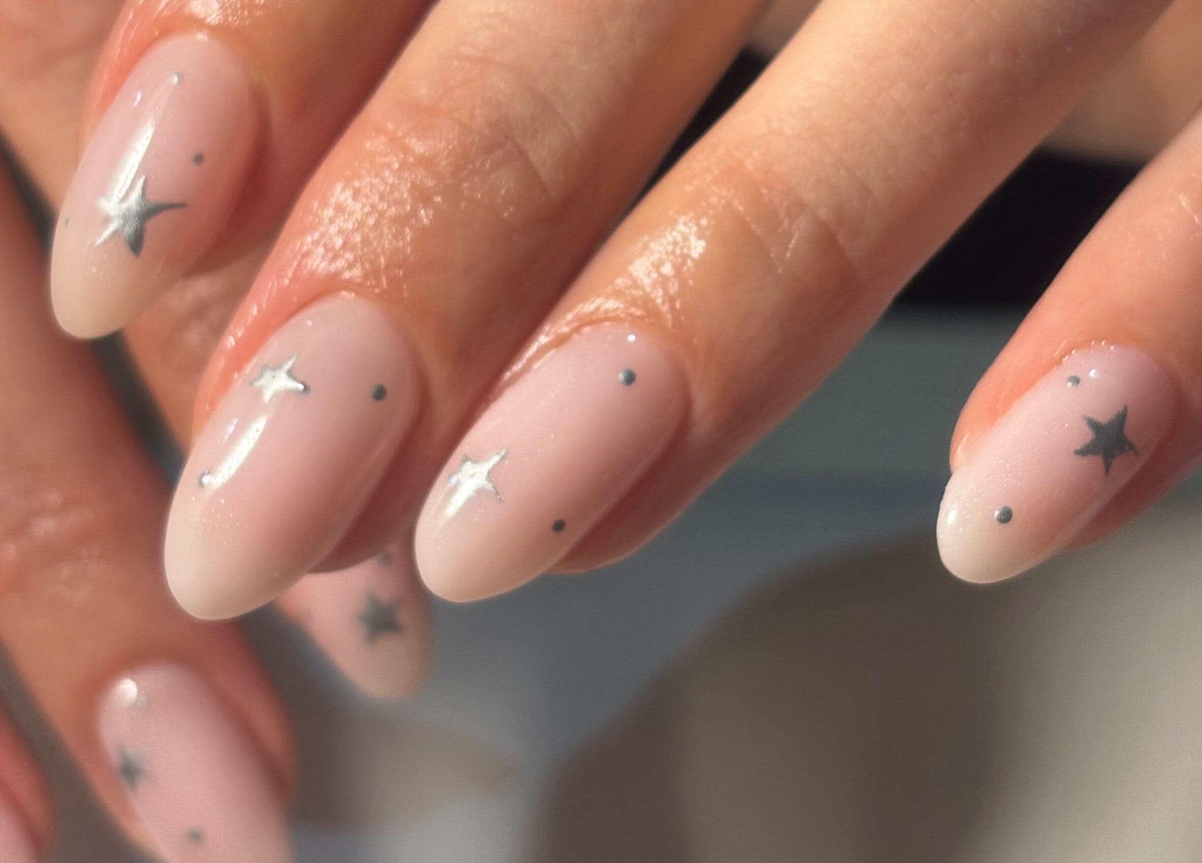 Stylish star-themed nails at Kana's Alter Ego Nail Studio in Ashmore, Queensland, AU.