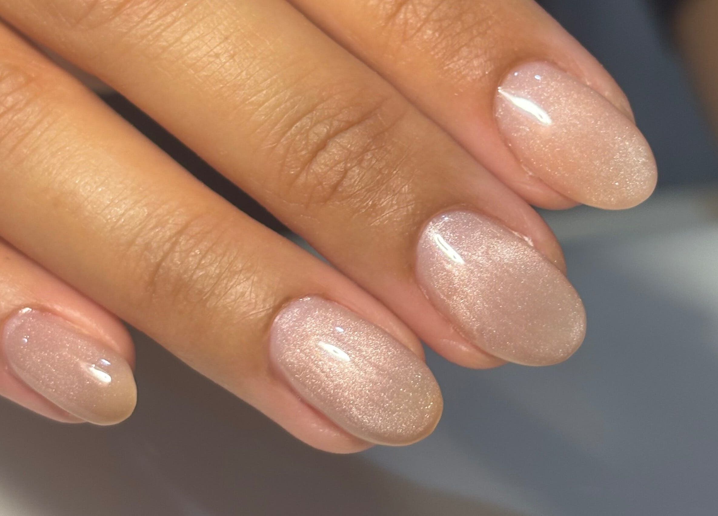 Elegant pink nails at Kana's Alter Ego Nail Studio, Ashmore, Queensland, AU showcasing shimmering finish.
