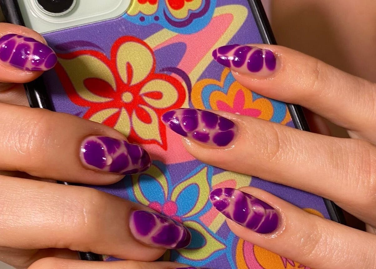 Purple nail art on phone case at Kana's Alter Ego Nail Studio, Ashmore, Queensland, AU.