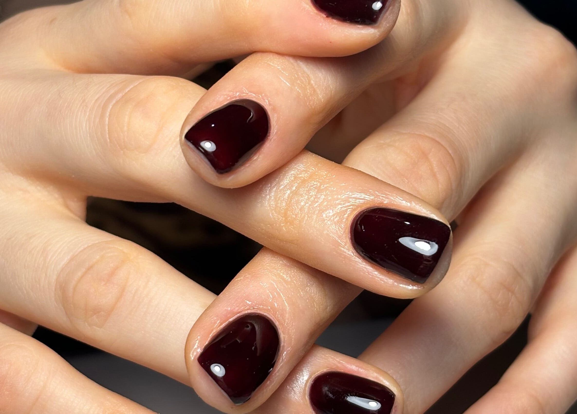 Elegant burgundy manicure at Kana's Alter Ego Nail Studio, Ashmore, Queensland, AU.