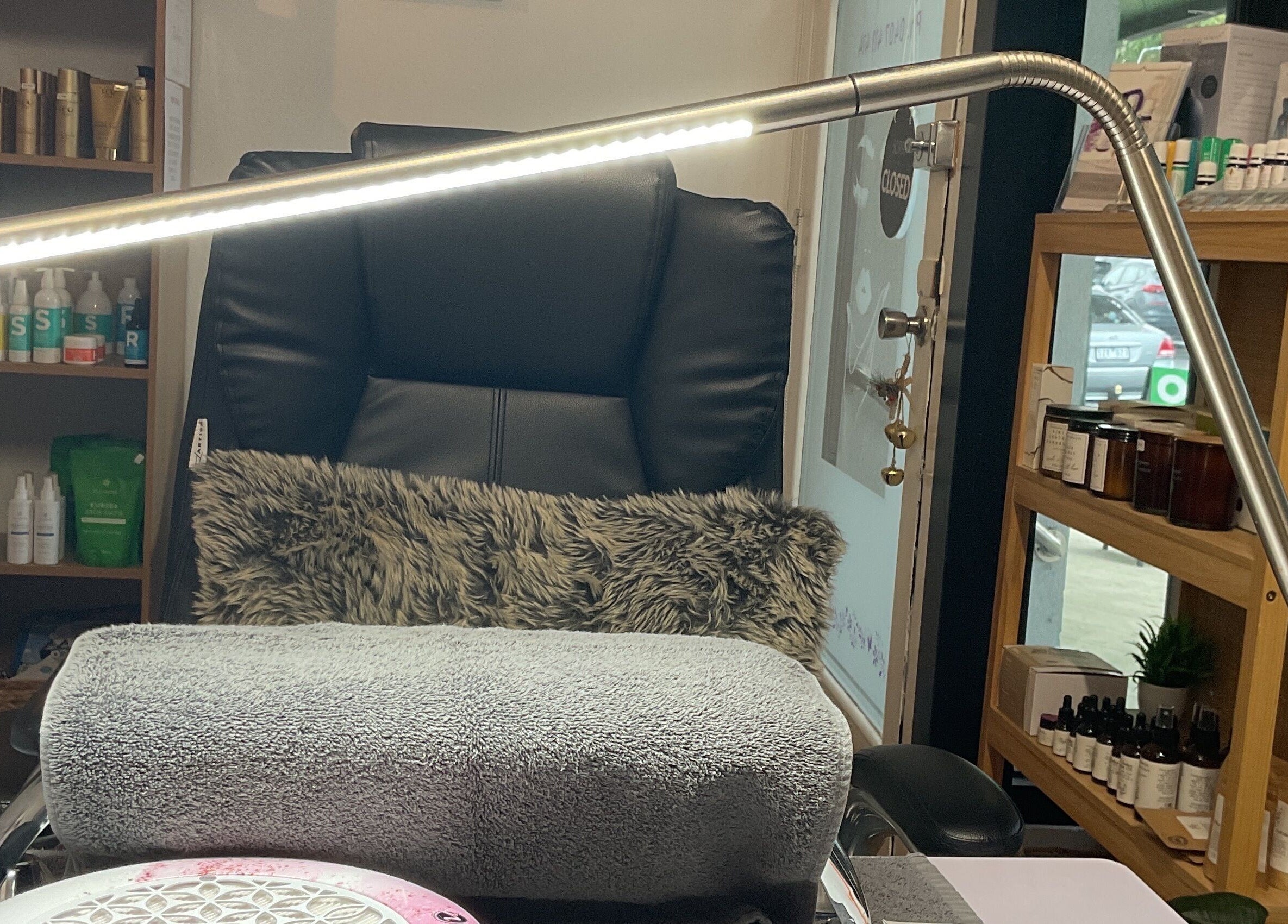 Comfortable nail station at Nails & More Salon, Maffra, Victoria, AU, with plush chair and organized shelves.