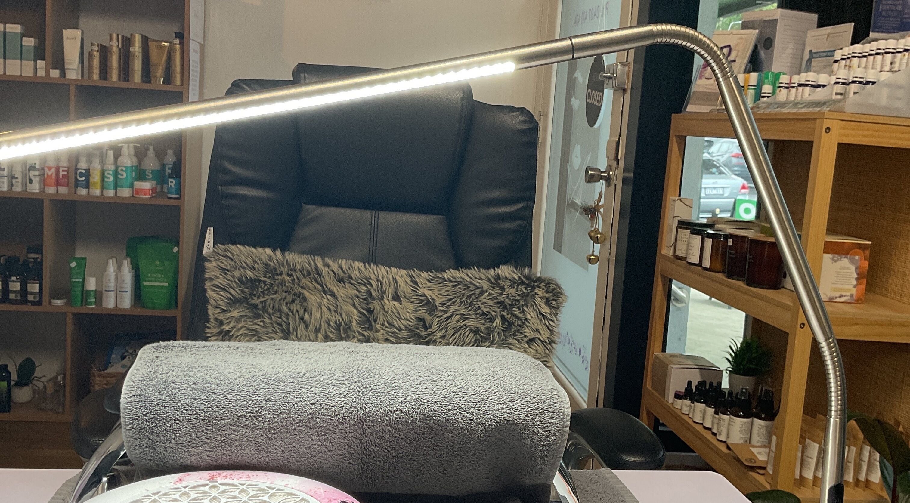 Relaxing nail station at Nails & More Salon, Maffra, Victoria, AU featuring plush seating and product display.