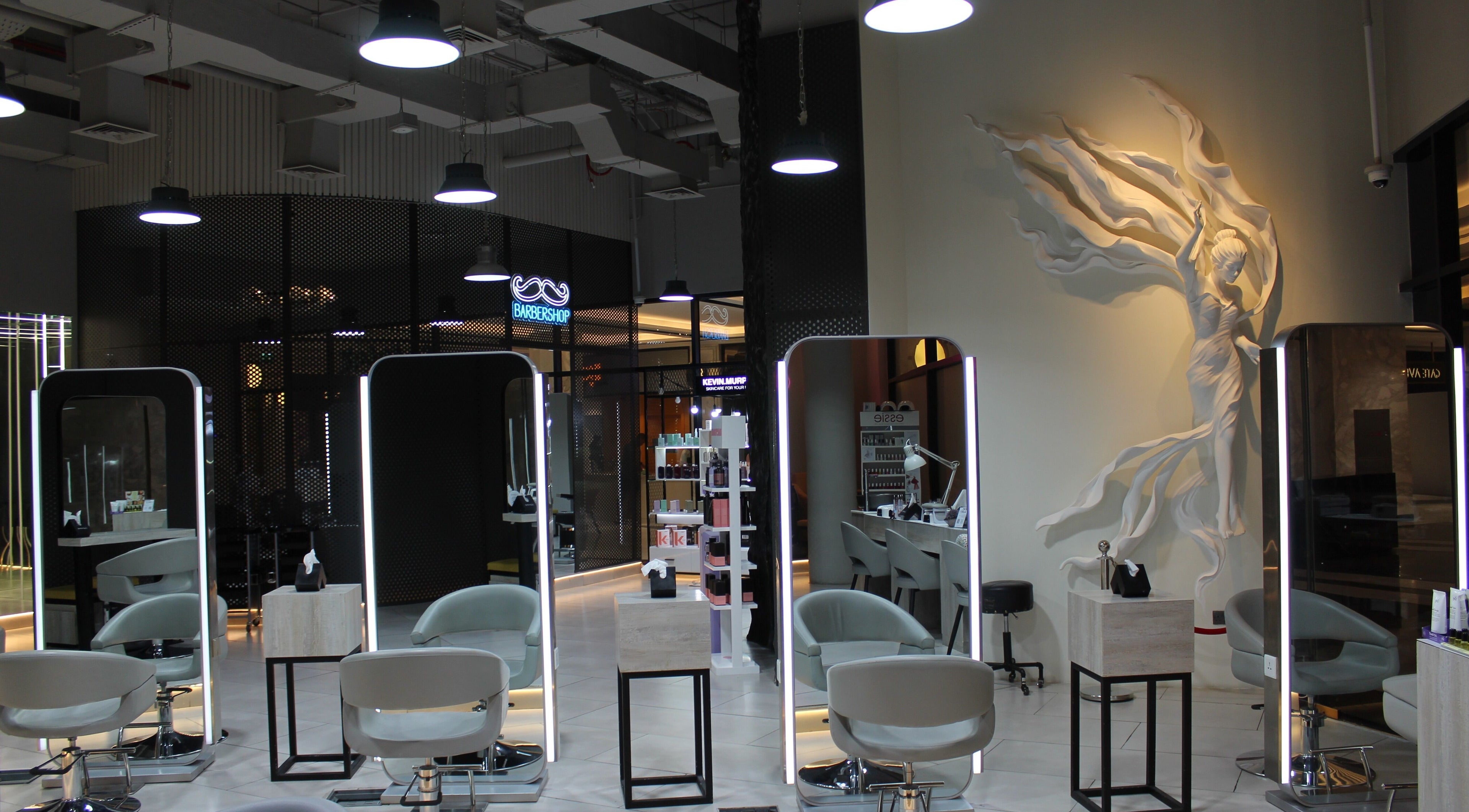 Interior of Cheveux Beauty Boutique in Dubai, AE, featuring sleek styling stations and a sculpted wall art.