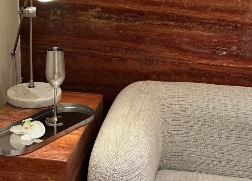 Elegant corner at Beyond Beauty, Ajman, showcasing a luxury lamp and armchair for relaxation.