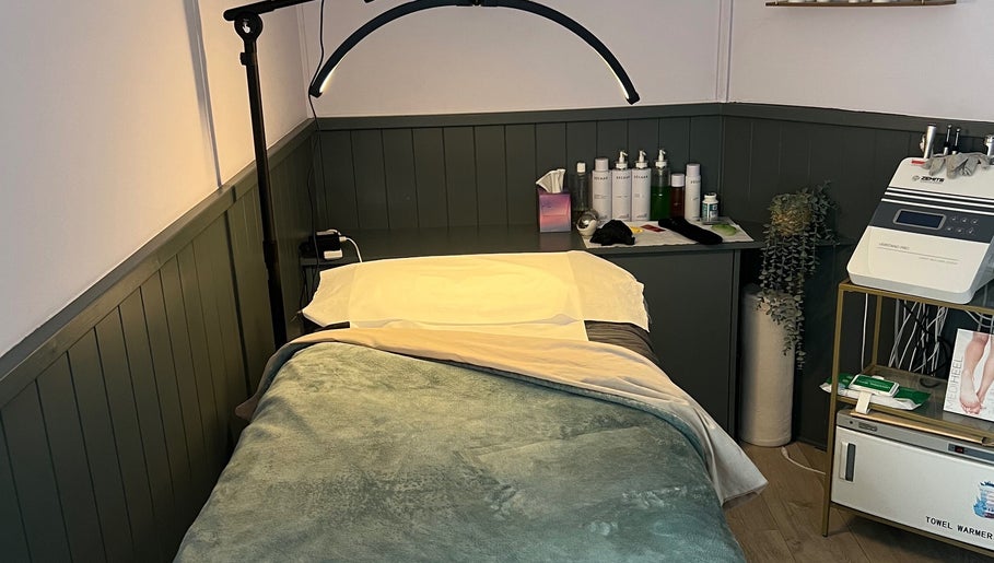 Cozy treatment room at The Beauty Cabin Reigate in Reigate, England, GB with bed and skincare products.