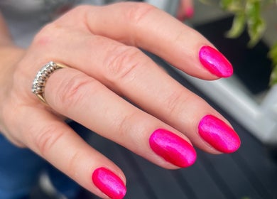 Vibrant pink nails manicure at The Beauty Cabin Reigate, Reigate, England, GB, showcasing elegance and style.