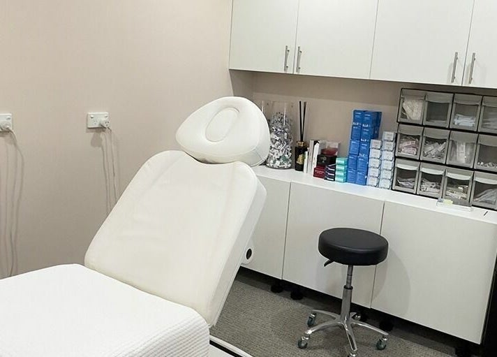 Relaxing treatment room at Reyoung Skin Clinic, Epping, New South Wales, AU, featuring a spa chair and cabinets.