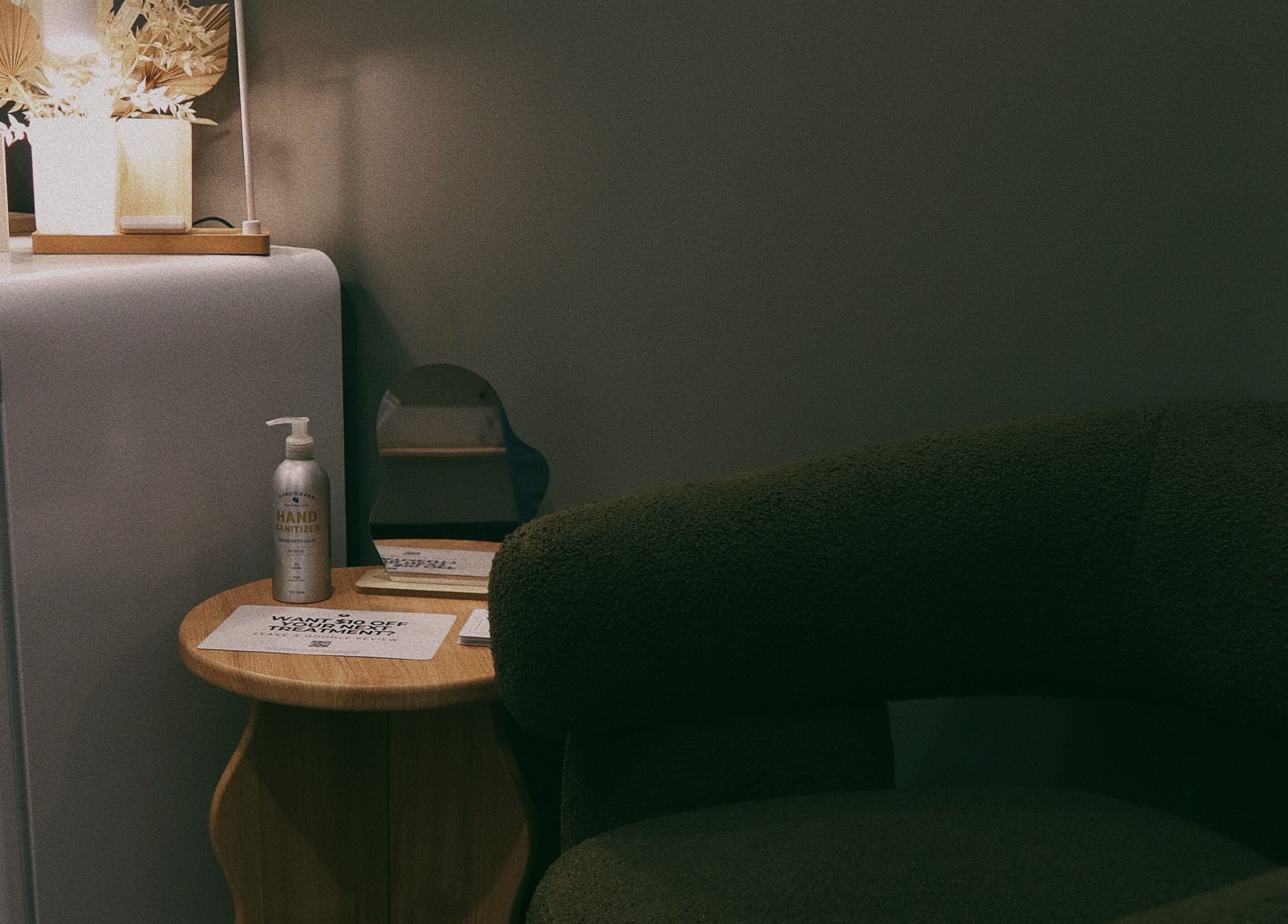 Lyla Skin Studio waiting area with chic decor and sanitizer in Aliso Viejo, California, US.