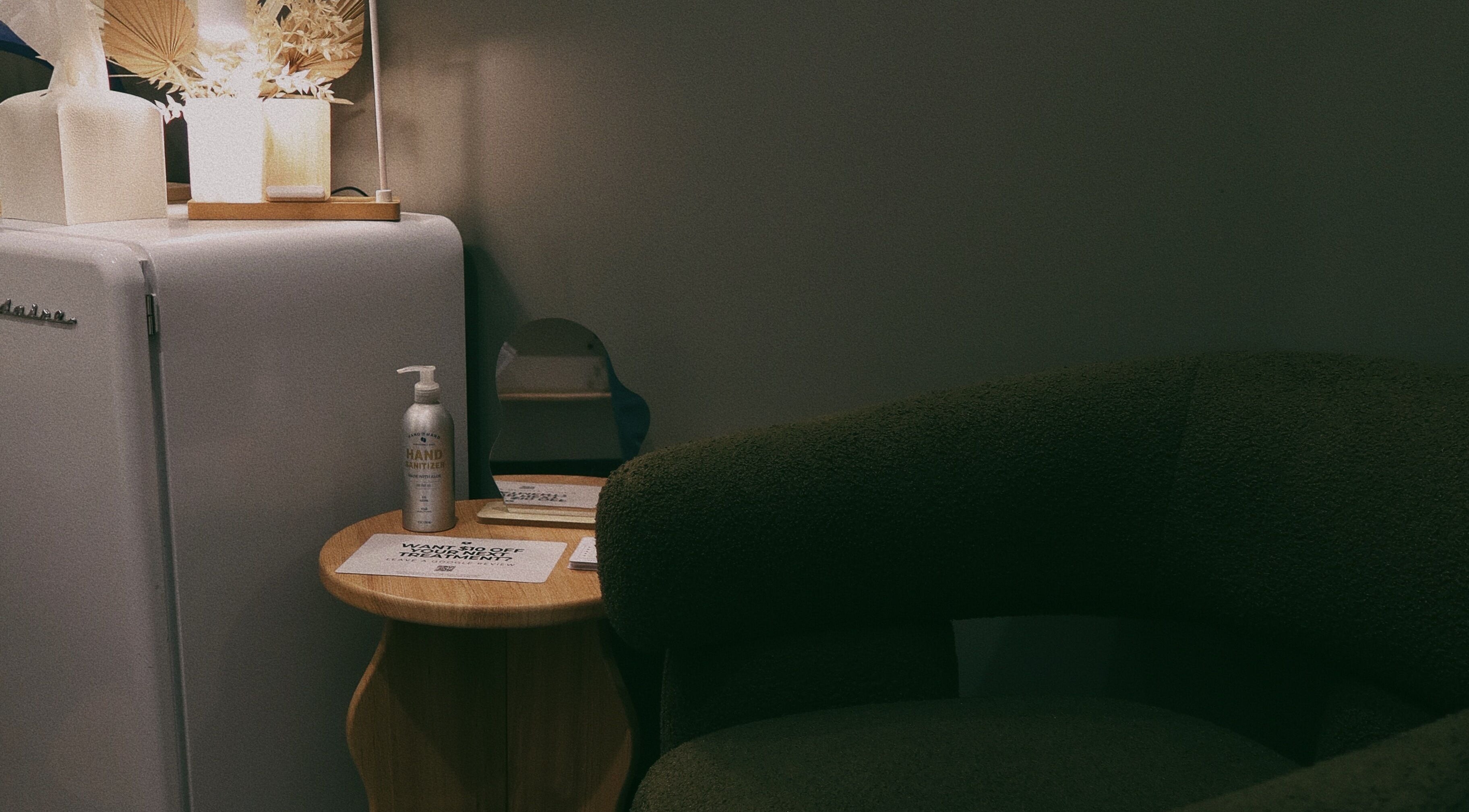 Lyla Skin Studio waiting area with chic decor and sanitizer in Aliso Viejo, California, US.