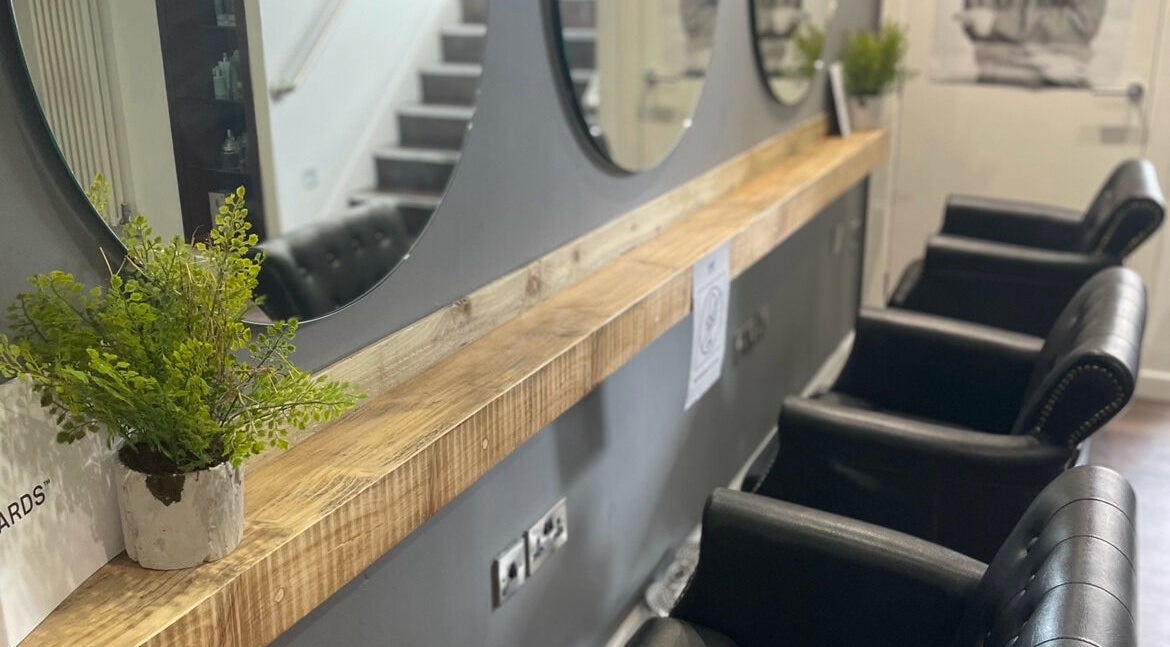 Stylish salon interior with mirrors and leather chairs at Stage 1 Hair, Harrogate, England, GB.