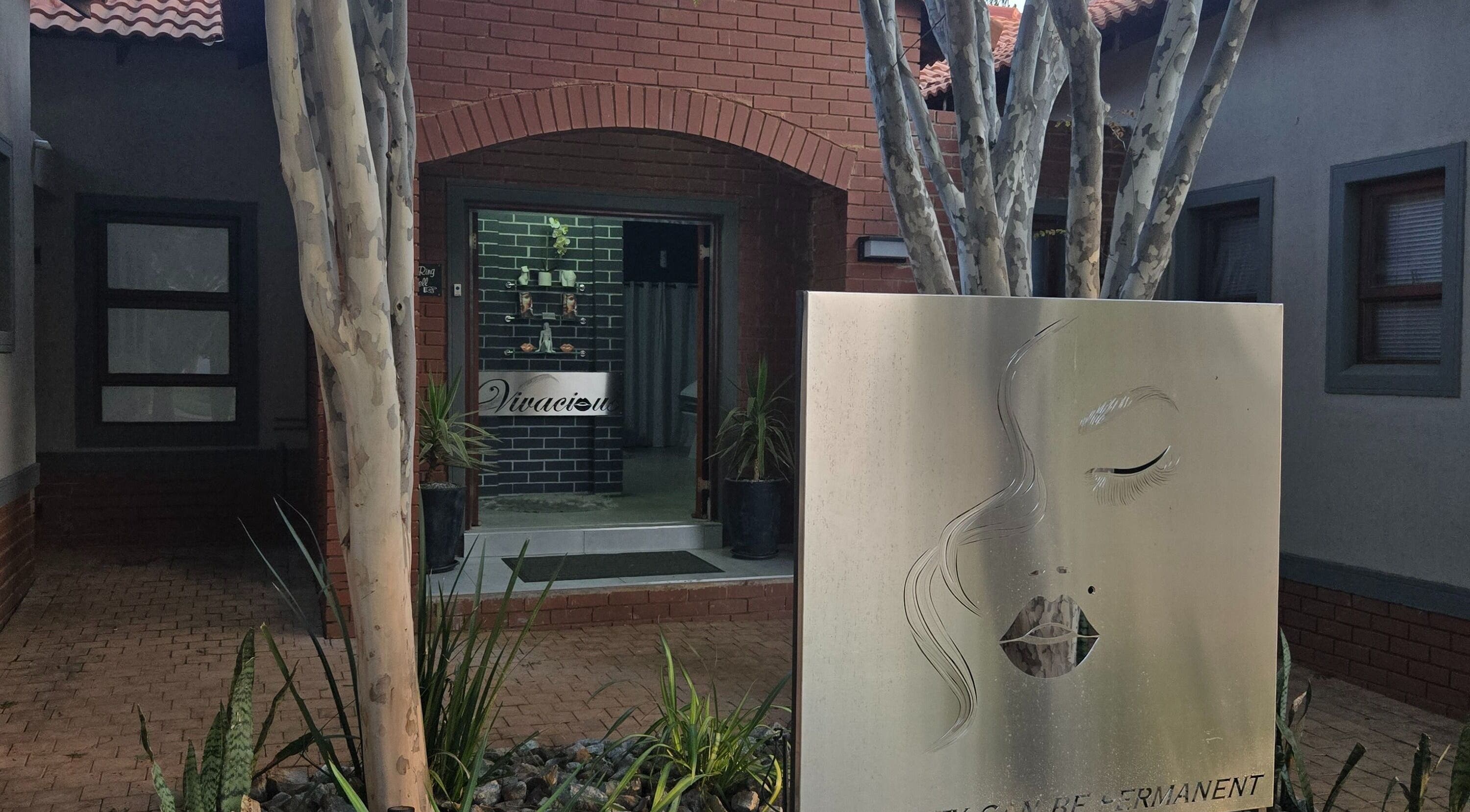 Entrance to Vivacious Permanent Beauty, Pretoria, Gauteng, ZA featuring elegant signage and natural decor.
