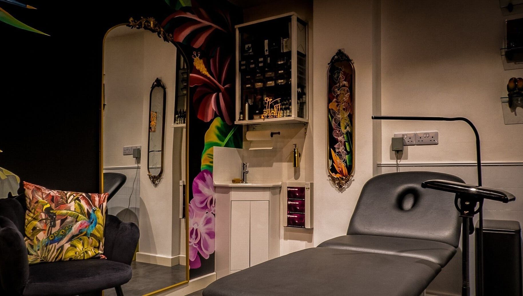 Stylish interior of Lucky Bird Tattoo Studio, Somerton, England, GB showcasing vibrant decor and tattoo chair.